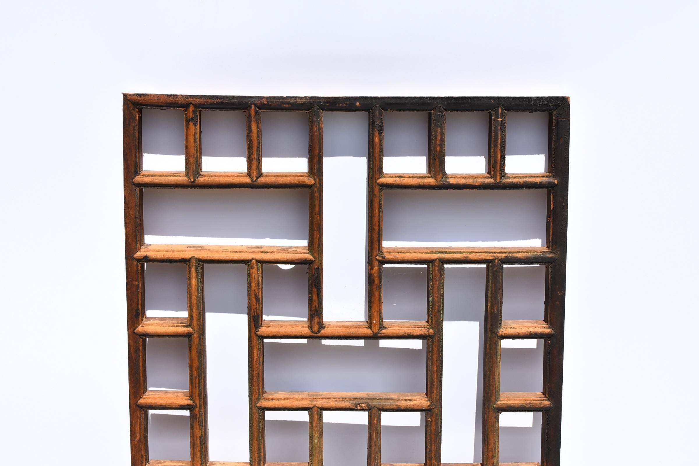 A 19th century screen with geometric design. 

The construction is joinery with tenons and mortises. All painstakingly done by hand. This piece makes a modern wall decoration besides being a screen.

Solid wood.