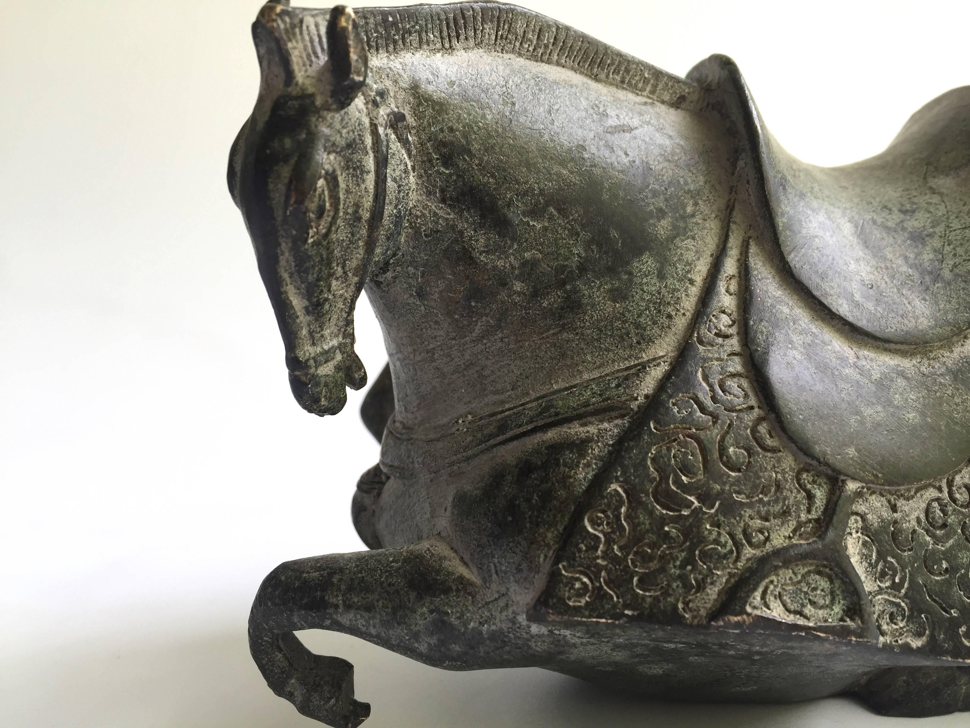 Exquisite bronze horse in Han style. The craftsmanship is superb with outstanding artistic expression. The scale and proportions of the horse's body follow an ancient model that has an almost modern feel to it. The muscles are well defined and