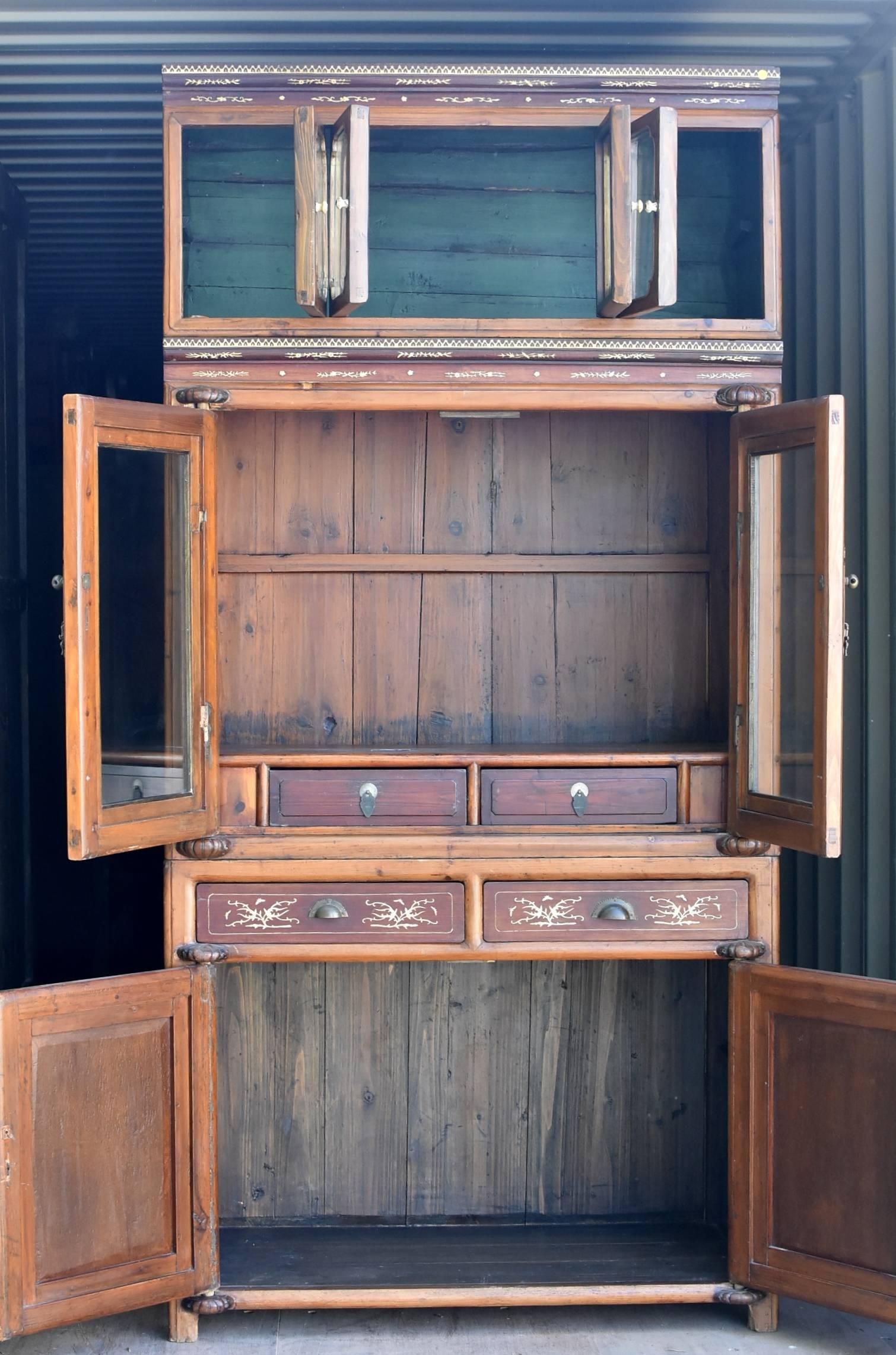 This exceptional 3-tiered piece is an authentic turn of the century antique cabinet from Ning Bo Province. The use of two toned woods is a traditional approach. The darker wood is single panel rosewood, highly prized and desired by the Chinese