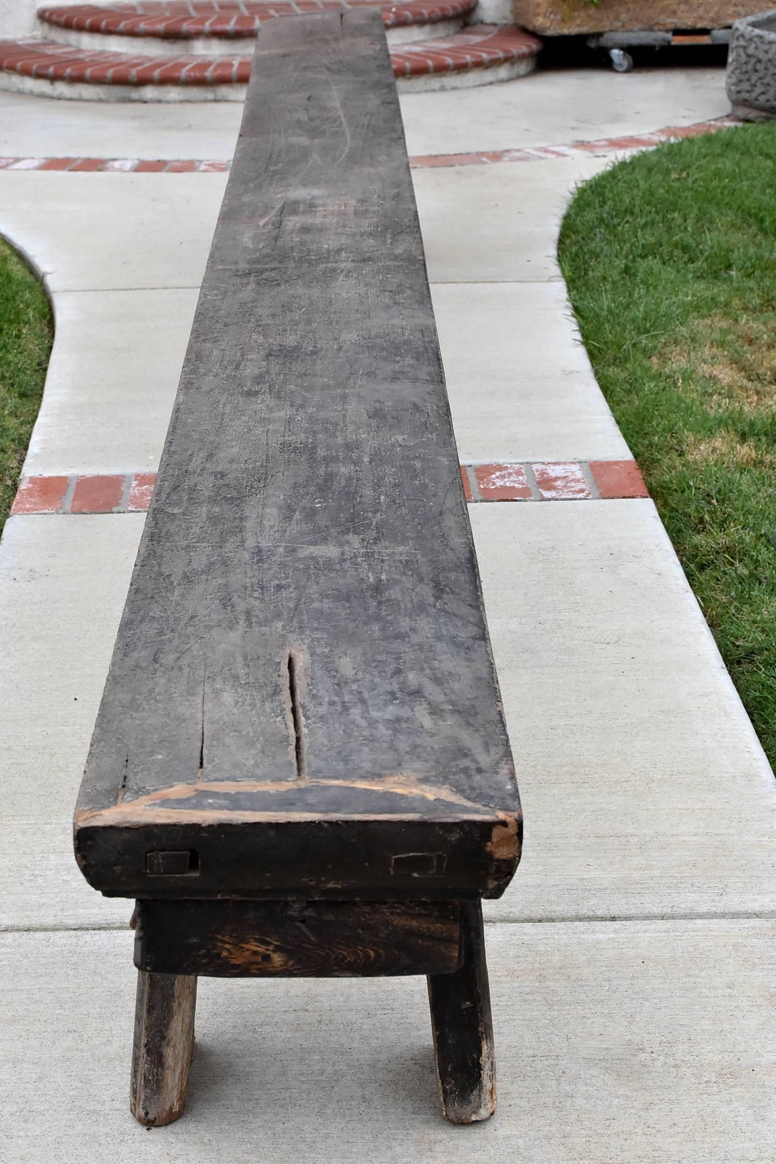 An extraordinary bench that measures 16'4" long. 

This rare piece came from Shan Xi, China. The top is one single board that is 3.5" thick and 13.5" wide! The legs are 6" wide! All solid, single board of wood. Brackets of