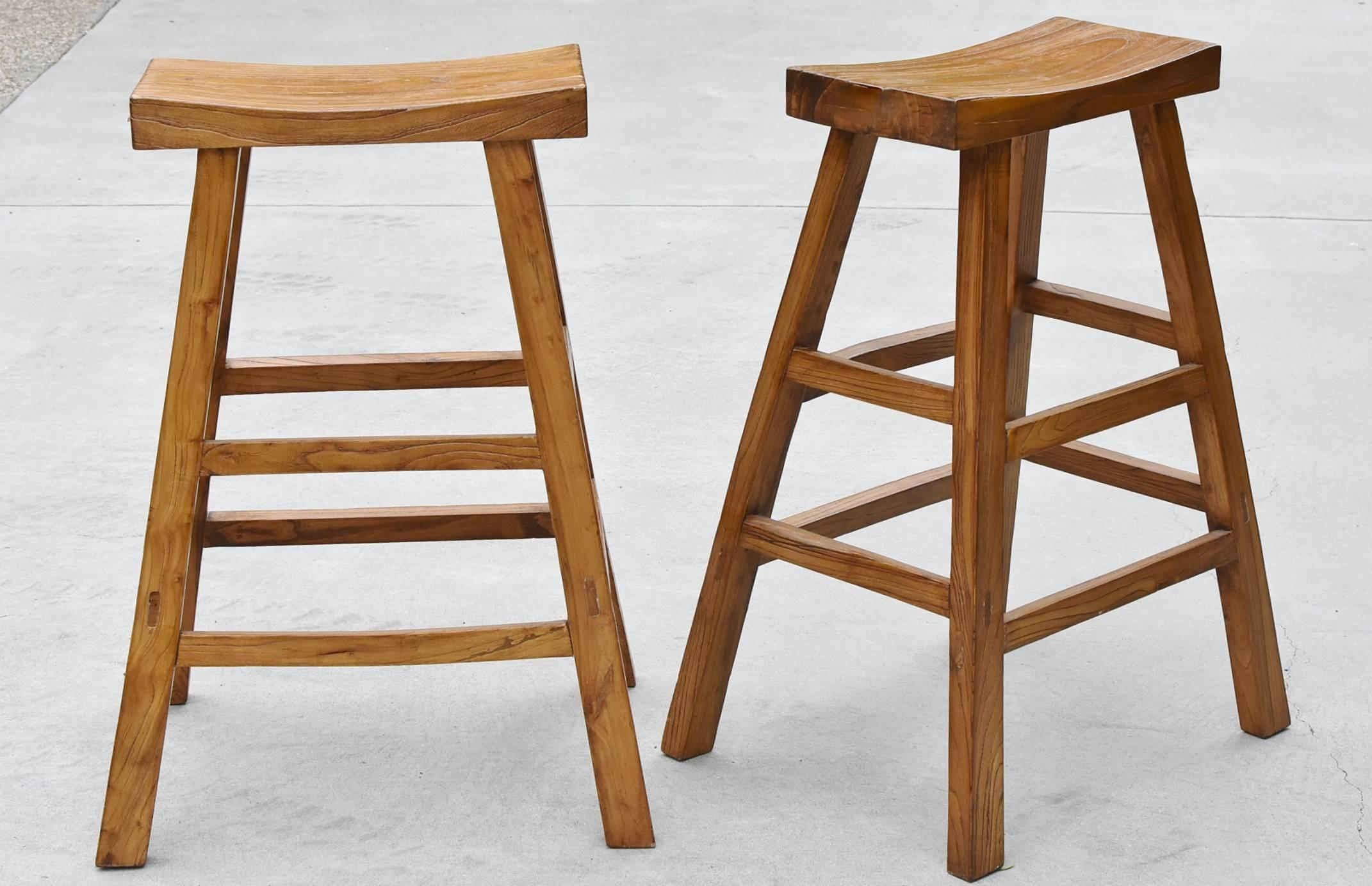 A pair of beautiful solid wood bar stools. 

The choice wood is elm. Elm has graceful swirls that resembles the soft slopes of Chinese mountains. These stools are very well made using tenon and mortise joinery. The wood used as stool's seats are