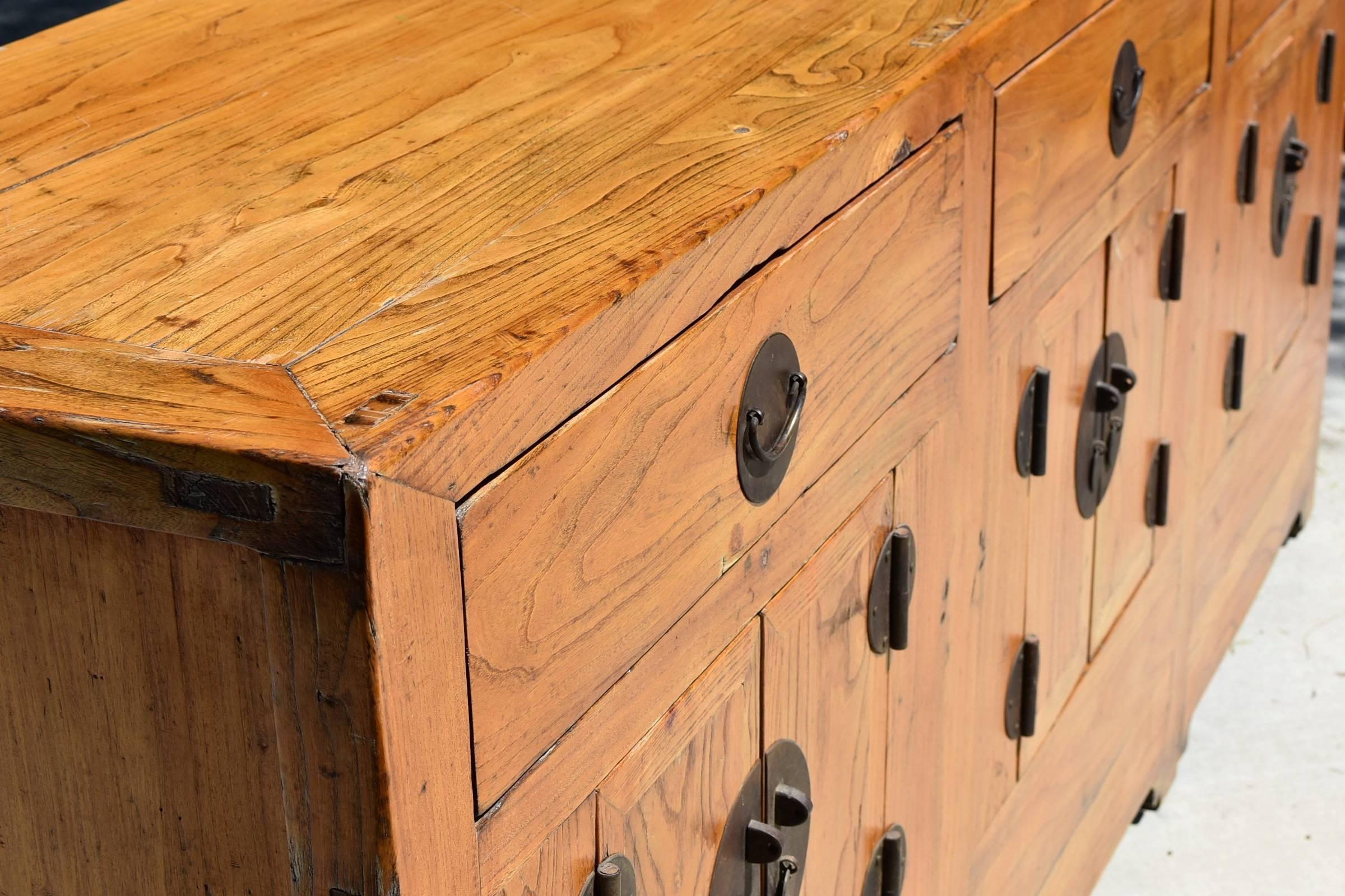Beautiful chest is handmade using the best elmwood that showcases its amazing mountain-like grains. Three very large drawers and compartments concealed by three pairs of doors offer ample storage. Handsome brass hardware enhances its timeless