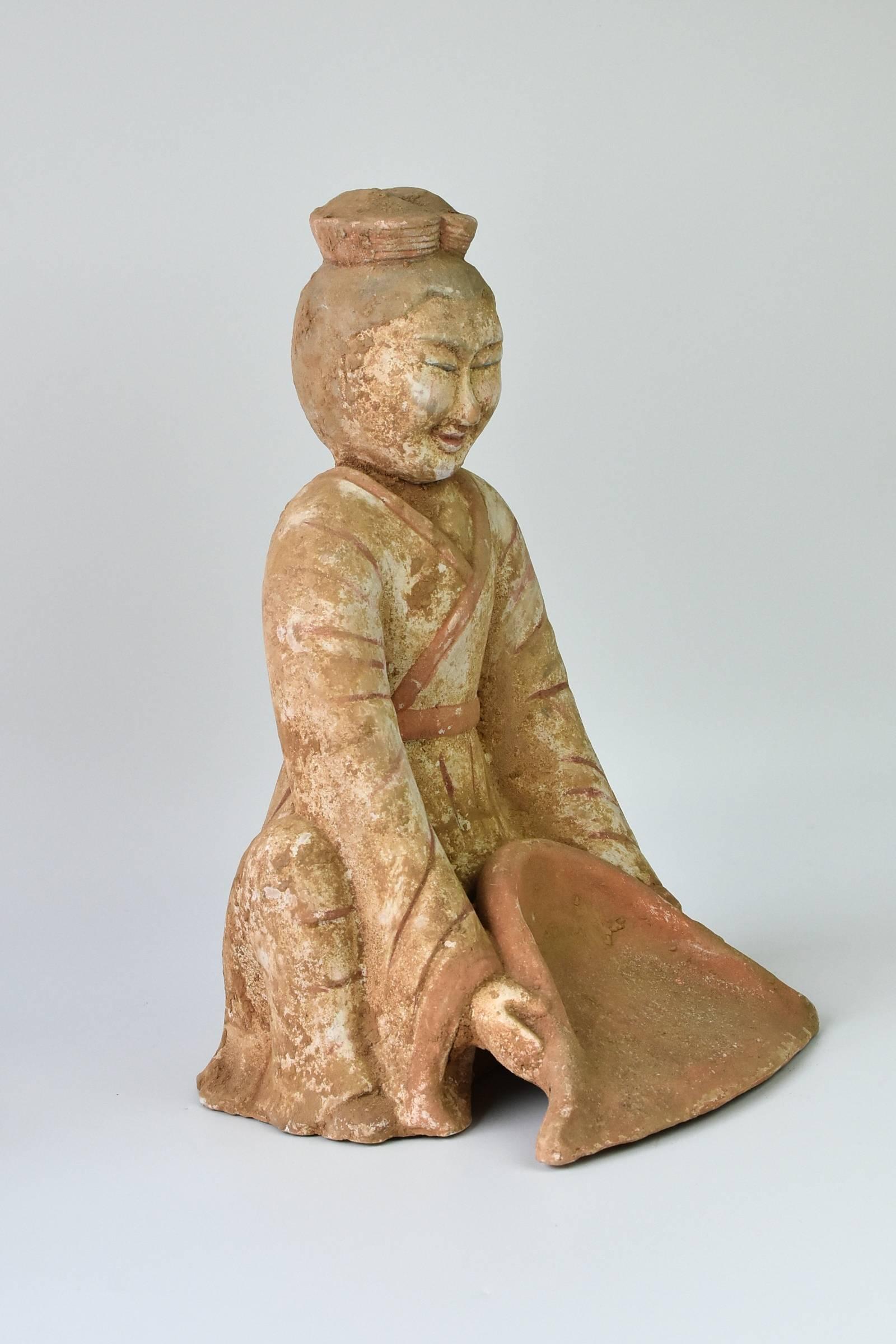 A most unique Han dynasty style piece depicting a farmer scooping grains. The facial features are distinctively of the Han style, which are thin with prominent bone structure. His outfit and hairstyle are also consistent with the era.
 