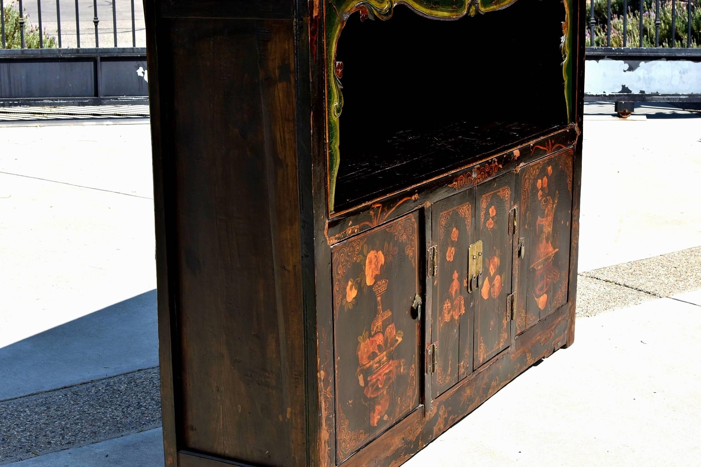 A beautiful Chinese scholar's chest with an open light feature and hand-painted images. Historically used to store books and scrolls, the top section has a hand-carved border gracefully outlining the open compartment. The lower half of the chest is