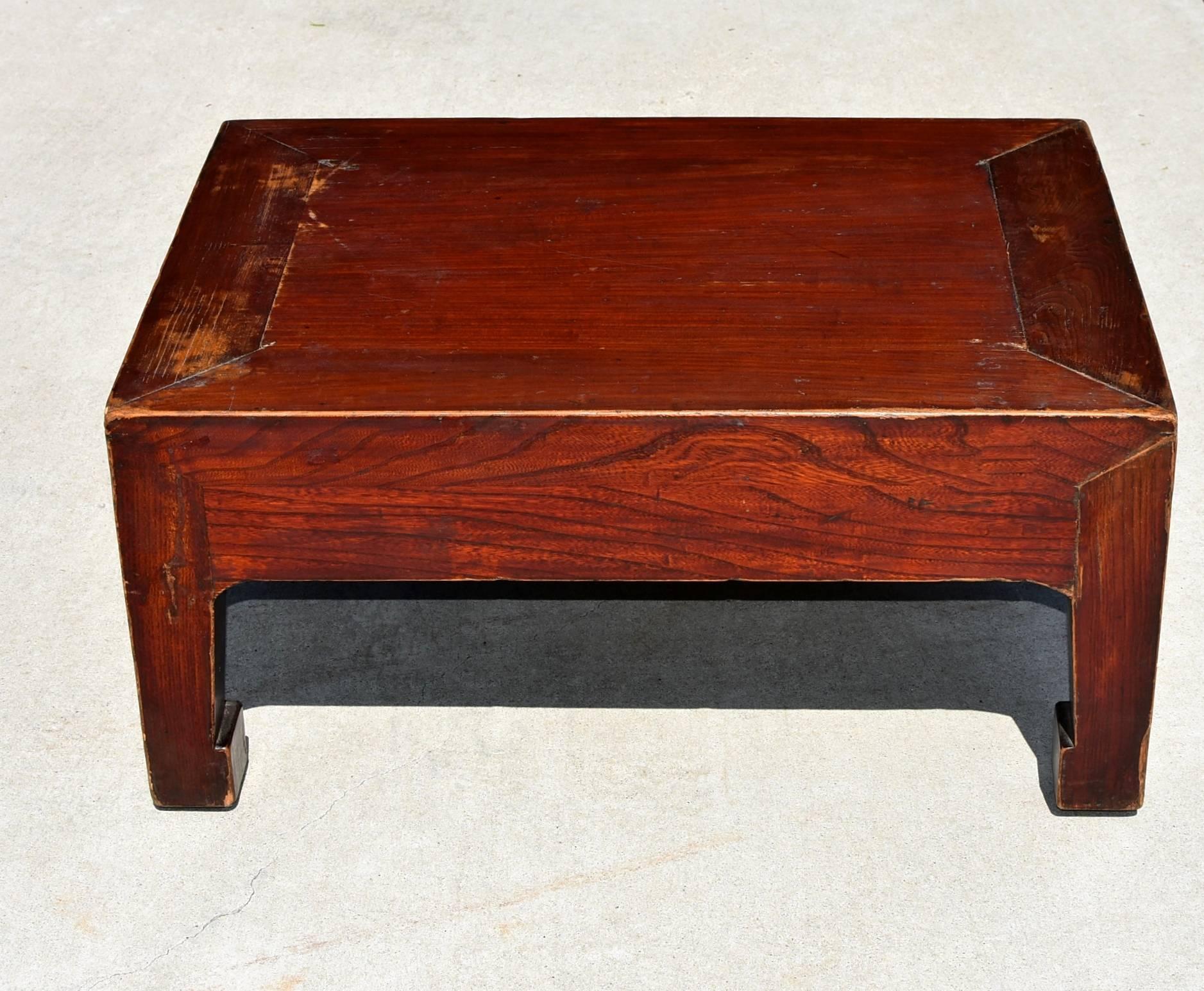 Beautiful low table is all solid wood with beautiful, reddish brown finish. Choice elmwood. Hoof legs. Chunky top is a typical Northern Chinese design. A versatile piece that can be used as a seat, table and a stand.

Solid wood. Tenons and
