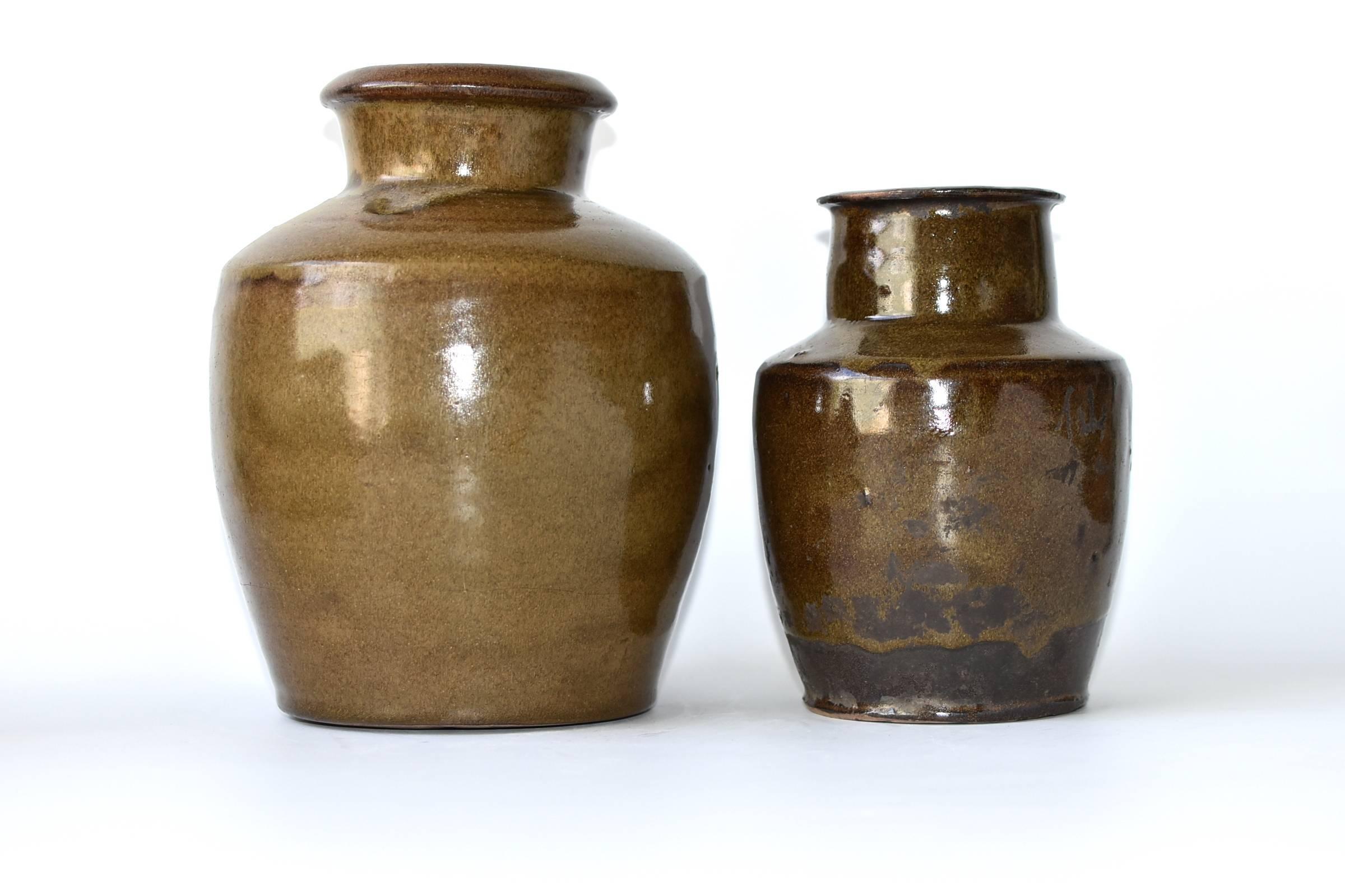 Beautiful antique jars with refreshing and unique olive color and dripped glazes. These wonderful pieces are from Shanxi province, an ancient state of China. The area is famous for producing rich, aromatic, dark vinegar. Historically these jars were