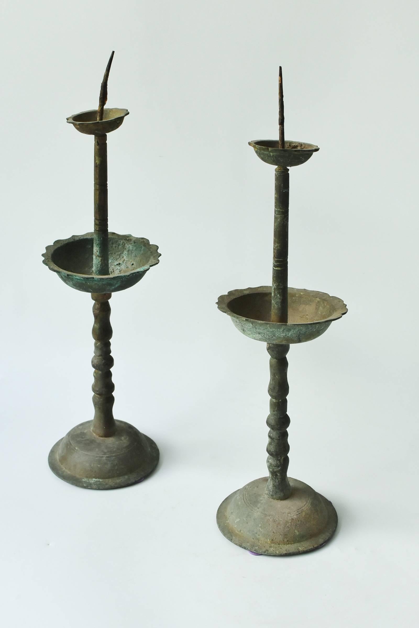 All original bronze candelabra from Northern China. Beautiful scalloped edges decorate the wax holding cups. Simple and elegant design.



 