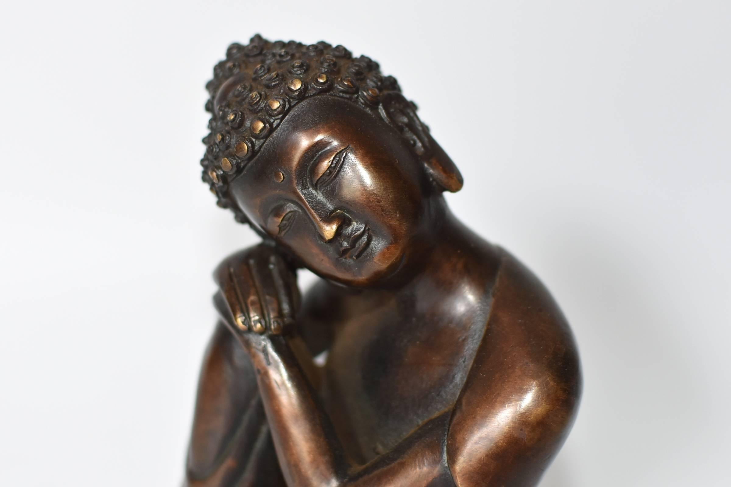 A beautiful bronze contemplative Buddha. This is a rare version of Buddha depiction, in an unique style. Through fine craftsmanship, the statue conveys a sense of peace and calm. This piece is small and exquisite, perfect as a desk top sculpture and