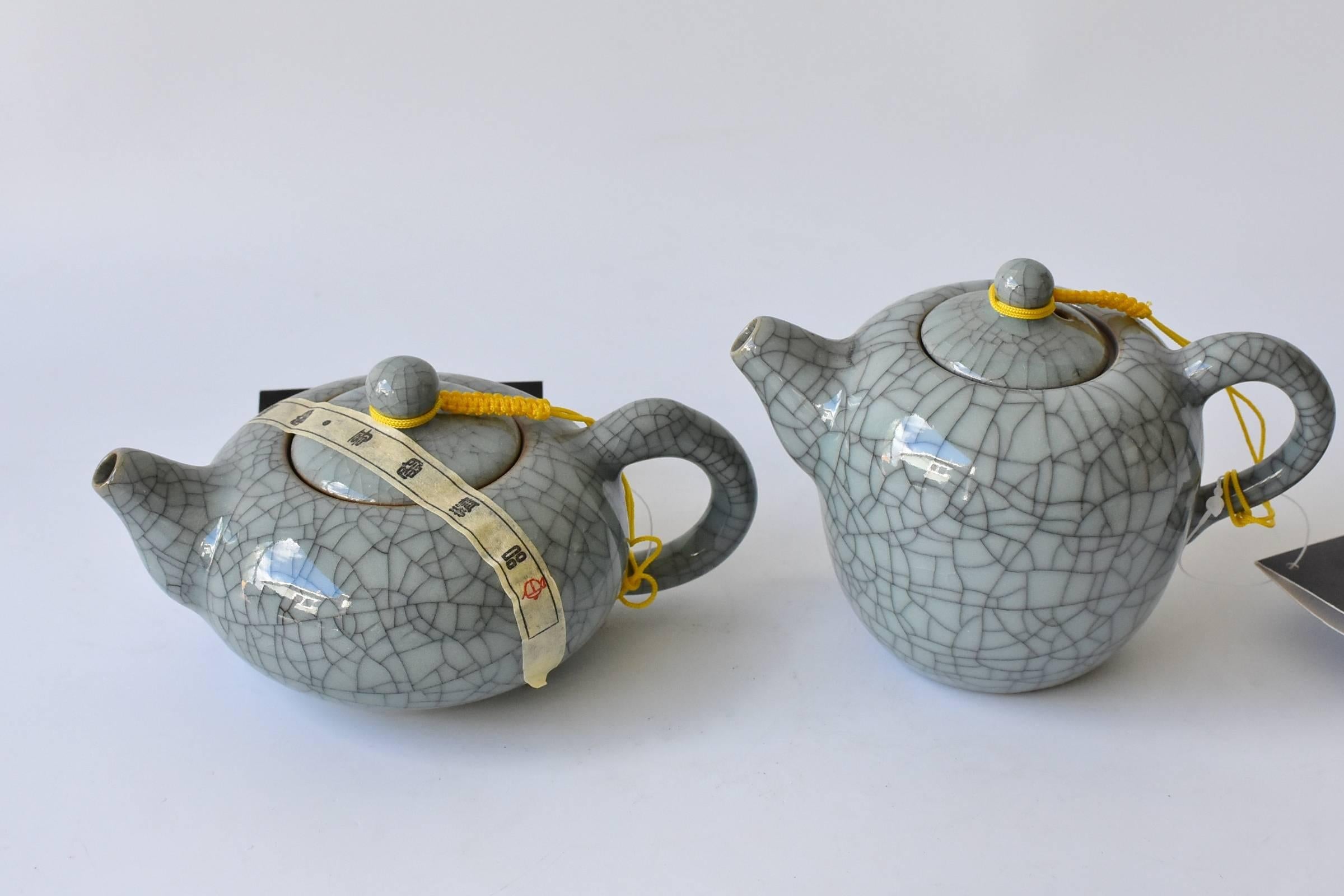A set of fully functional celadon porcelain consists 13 beautiful, brand new, hand made pieces. These are meant to be used, not just as decorations. There are two incense burners, one washer bowl, two teapots, eight tea cups. This type of porcelain