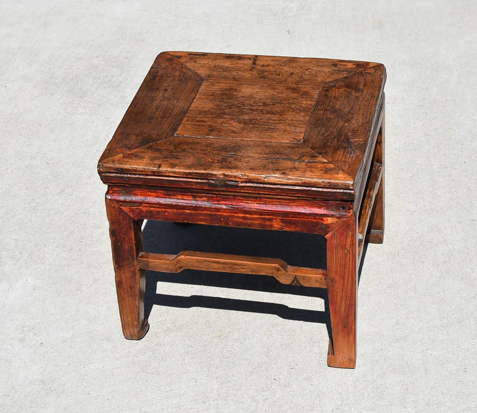 Rustic charm at its best. Small square stool is made of solid wood, using tenons and mortises. Raised stretchers and a waist add design interest. Hoof Legs enhance its country charm. Solid, sturdy, versatile. Shan Dong province.
 
