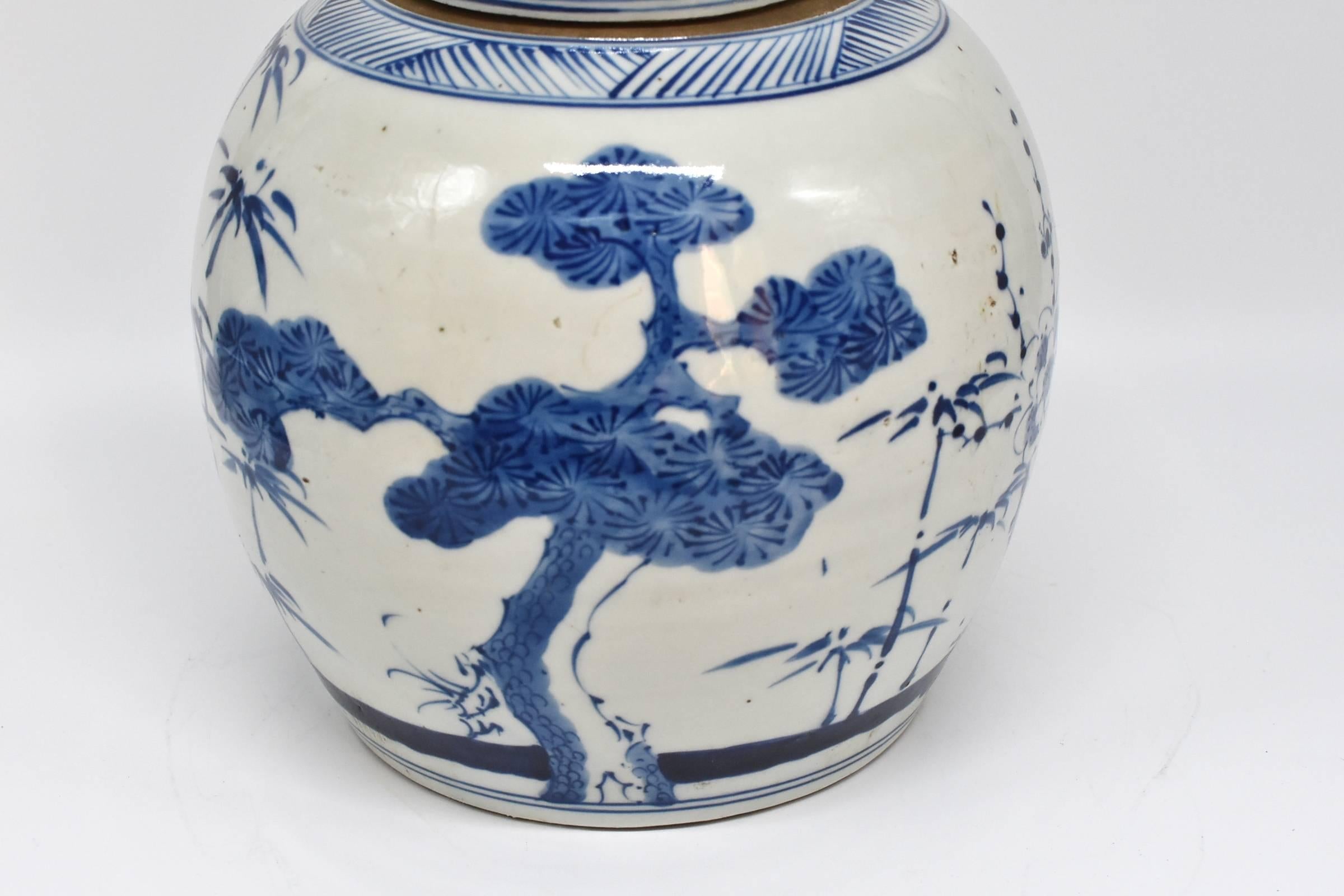 A beautiful 20th century Chinese blue and white ginger jar with hand-painted images of bamboo and pine trees. They symbolize advancement and longevity. The blue and white is a Classic color that is timeless. The colors on these pieces are beautiful