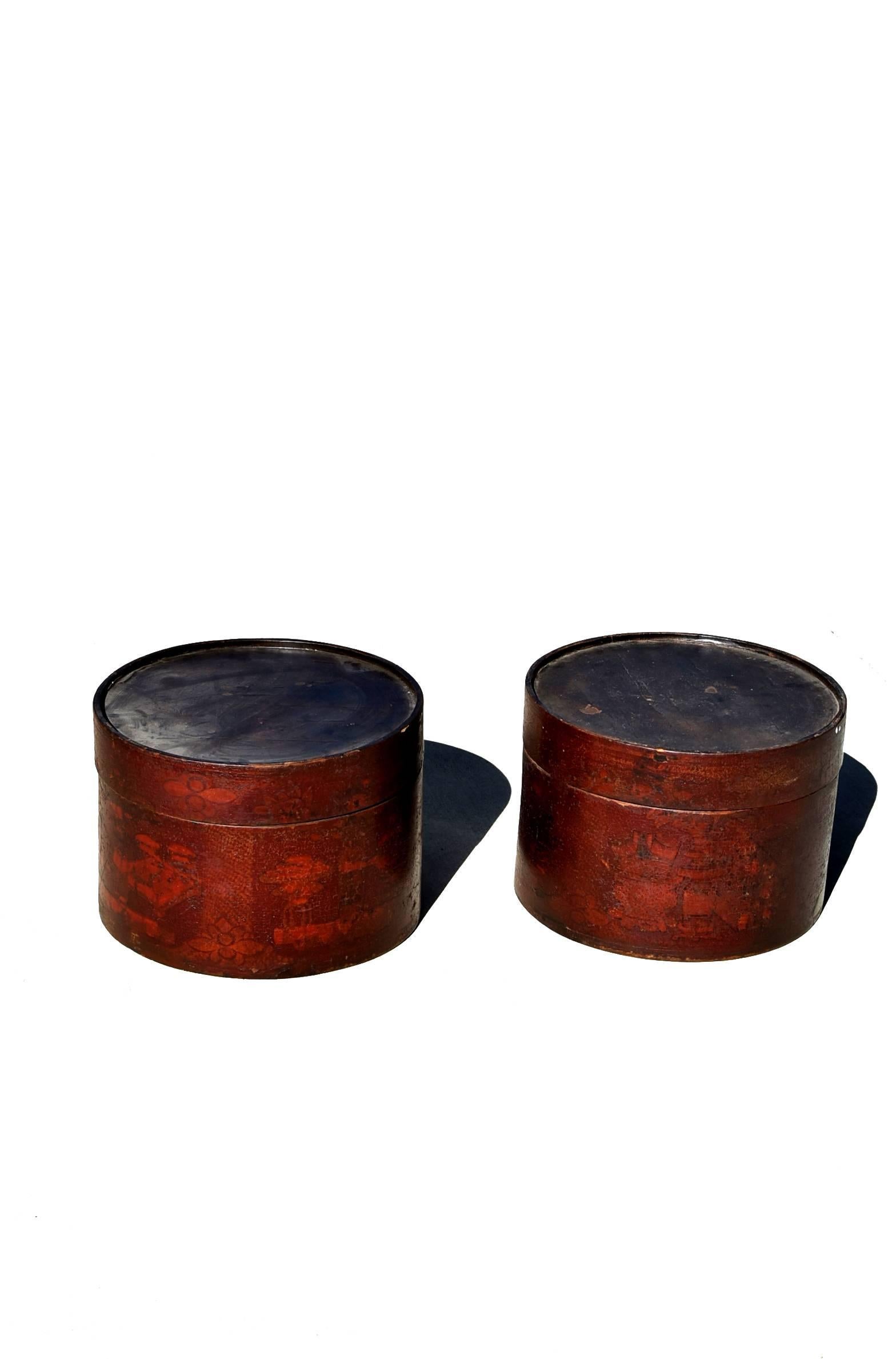 A pair of beautiful round boxes. Boxes are hand-painted with flowers and vases. Crackled patina enhances the charm.
