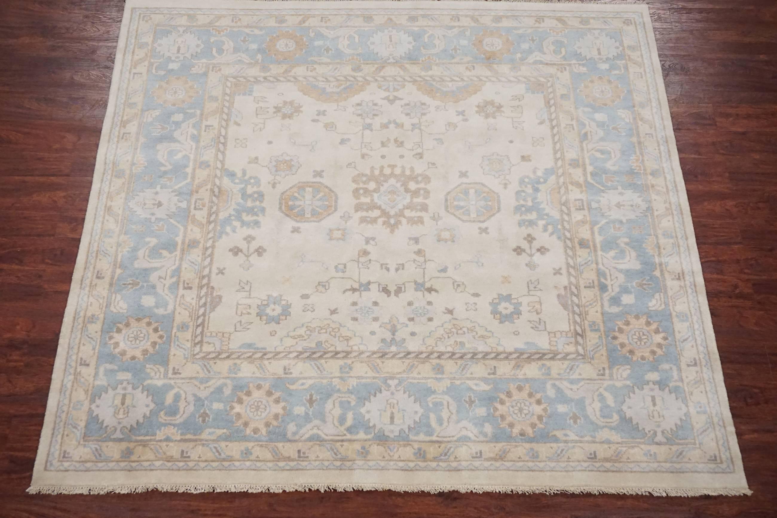 Ivory and light-blue square Oushak rug

2010

Measures: 7' 11