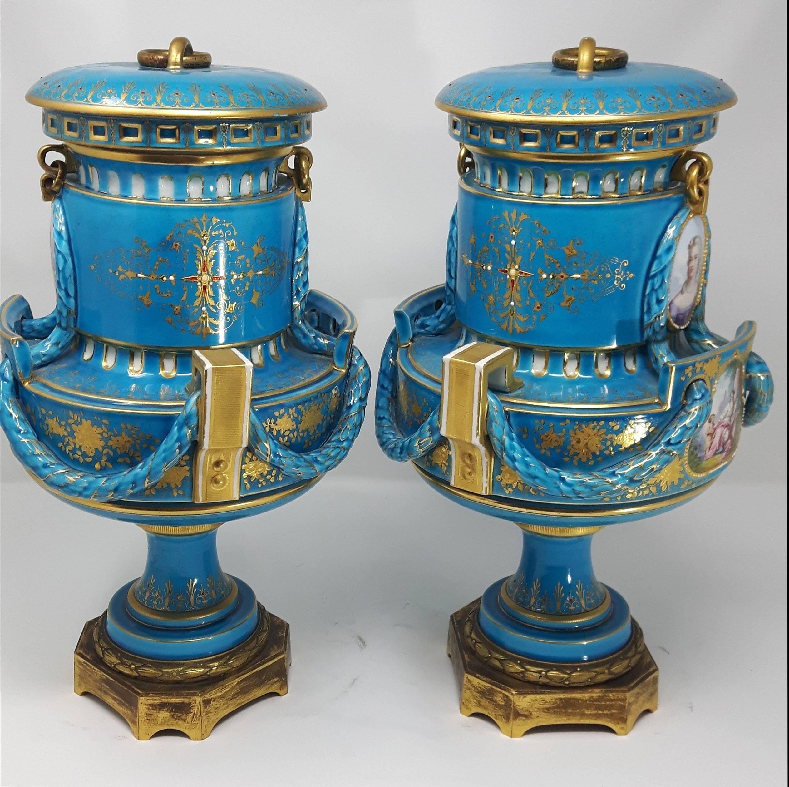 A fine pair of jewelled sever porcelain vases and covers painted with scenes of 
 figures surrounded in a gilt and jewelled borders against a turquoise background. 

 