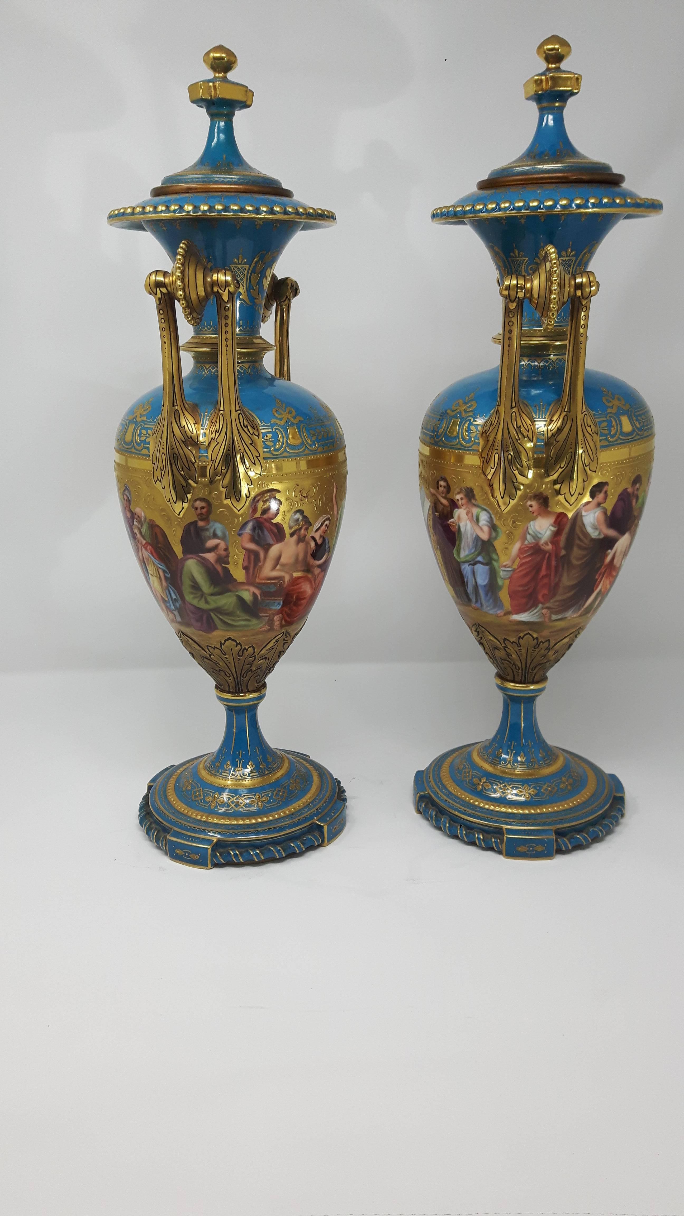 Pair of late 19th century Vienna vases. Each vase is finely painted with continuous reserve of classical allegorical figures on a gold background.