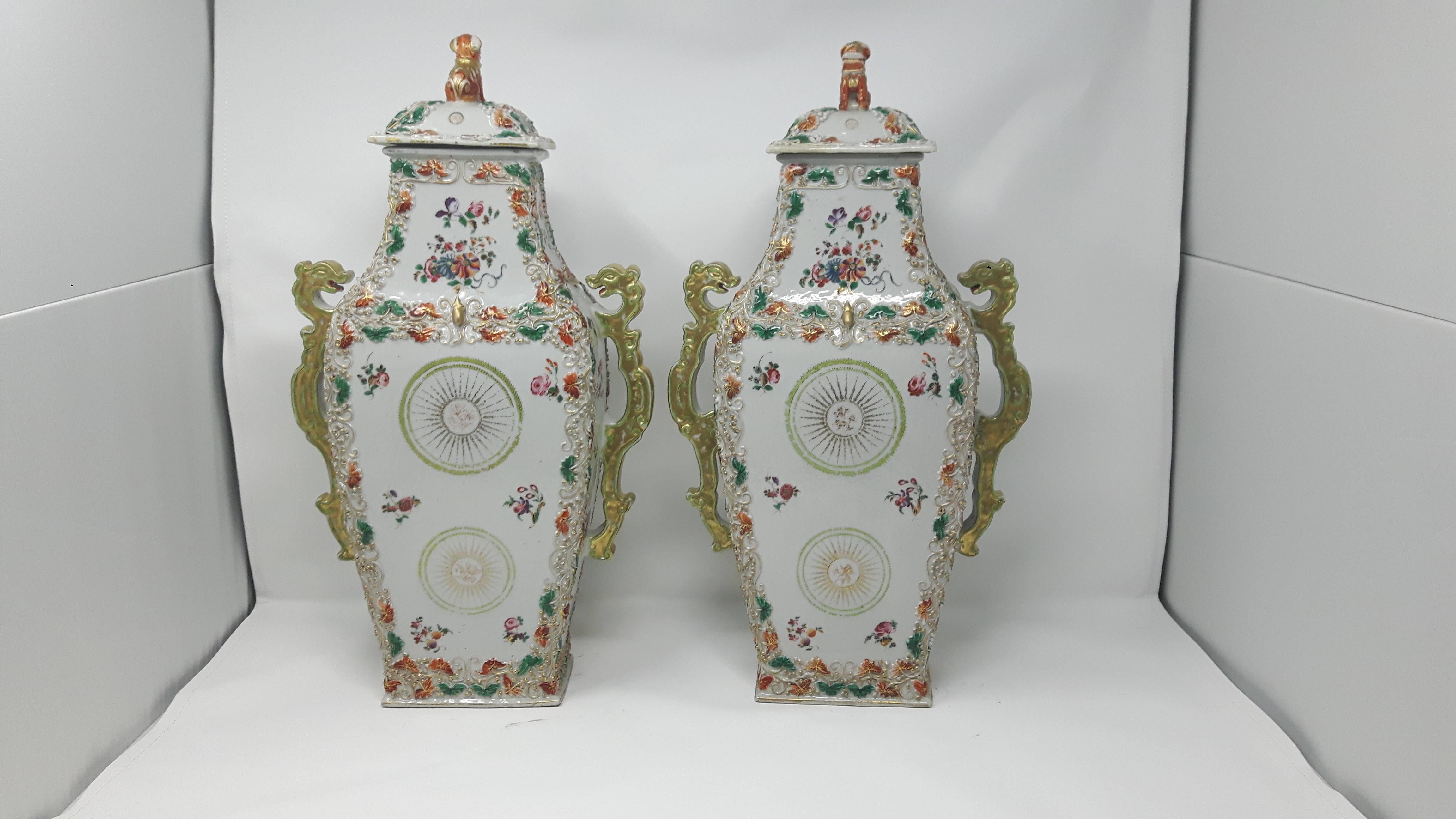 A pair of 18th century famille rose vases painted and applied decoration of squirrels flowers and leaves.