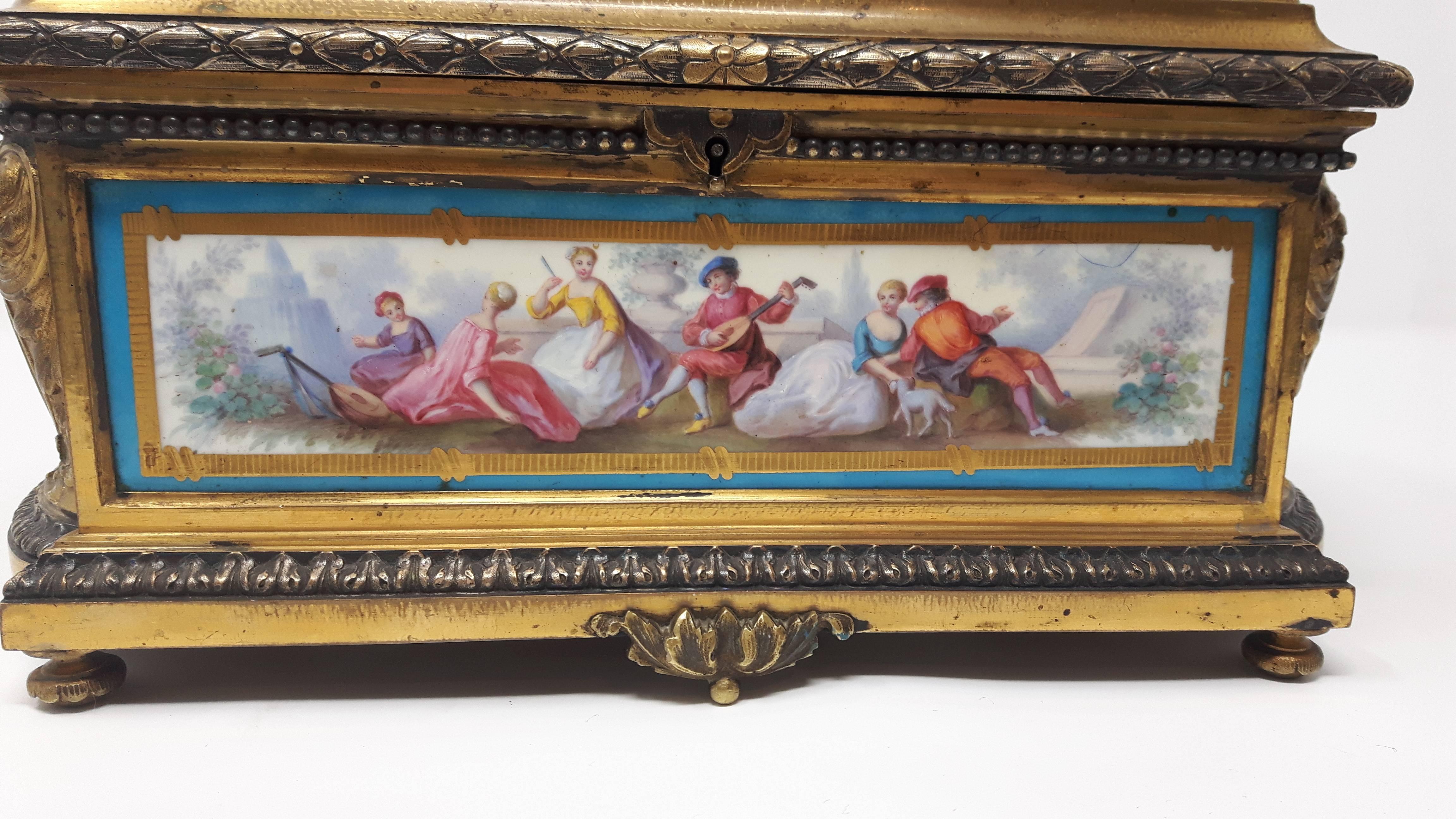 A rare antique French gilt bronze and silver Sevres porcelain casket finely painted with neoclassical figures on two round and two rectangular plaques.
