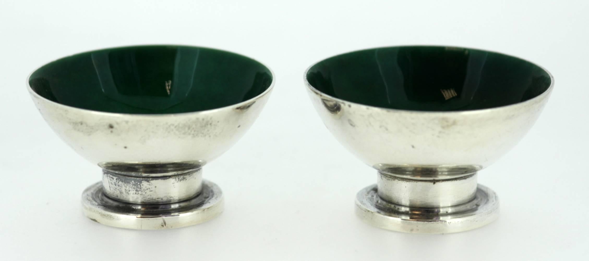Vintage sterling silver and green enamel pair of egg holders 
Made in USA, circa 1980 
Maker: Georg Jensen USA 
Fully hallmarked. 

Dimensions: 
Diameter x height: 5.55 x 3.2 cm 
Weight: 96 grams total 

Condition: Minor surface wear from