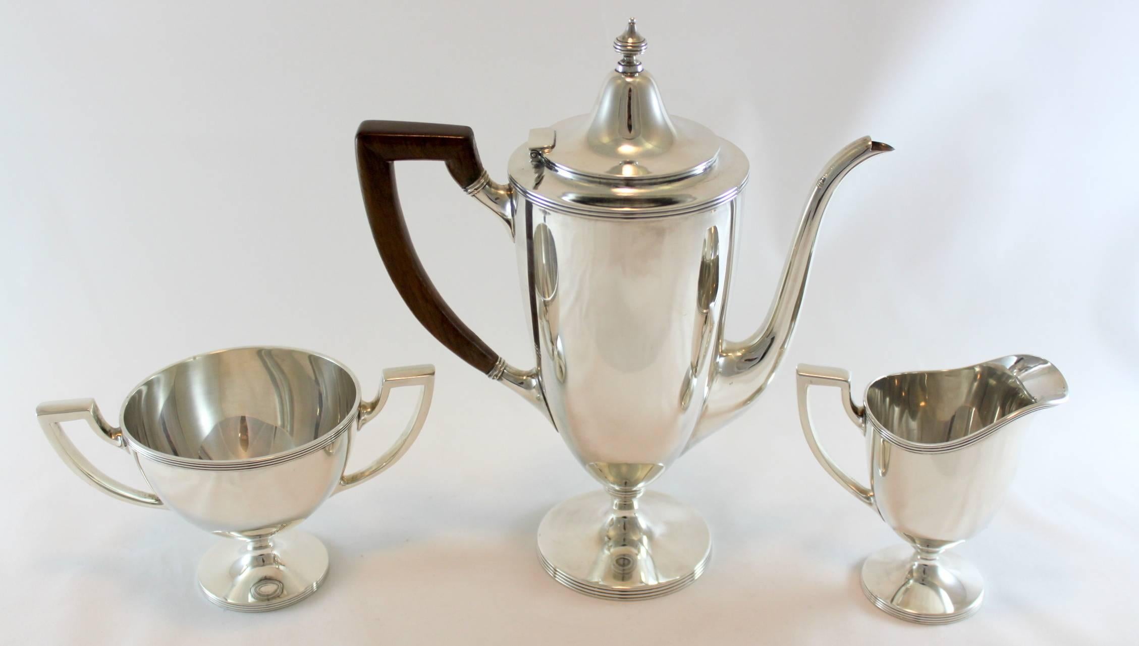 Vintage sterling silver tea set
New York, circa.1947-1956
Maker: Tiffany & Co ( Directorship of Louis deBebian Moore )
Fully hallmarked.

Dimensions: 
Tea pot: 20.2 x 9.1 x 23.5 cm
Weight: 526 grams.

Cream jar: 10.4 x 6.3 x 10.4