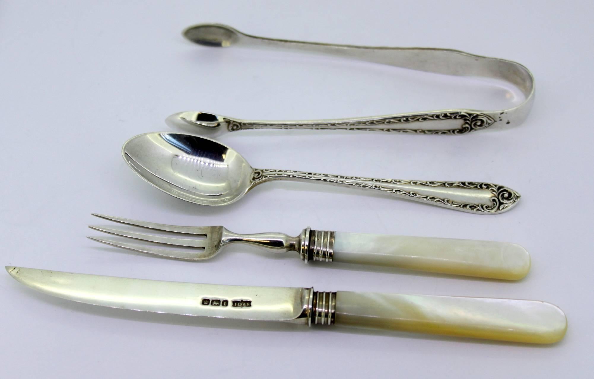 Antique silver and mother-of-pearl tableware set (Six knives, six forks, six spoons and one sugar tong)
Made in Sheffield 1903
Maker: James Dixon & Sons Ltd
Fully hallmarked.

Dimensions: 
Knife size: 15.5 x 1.3 x 0.6 cm
Weight: 24