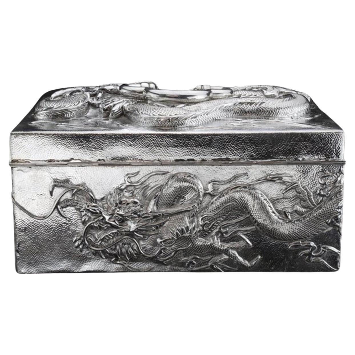 An impressive Chinese export solid silver dragon box, crafted circa 1880–1920 from substantial heavy-gauge silver, 900  purity and intended for the Western market. The rectangular form, with gently rounded corners and a hinged lid, is beautifully