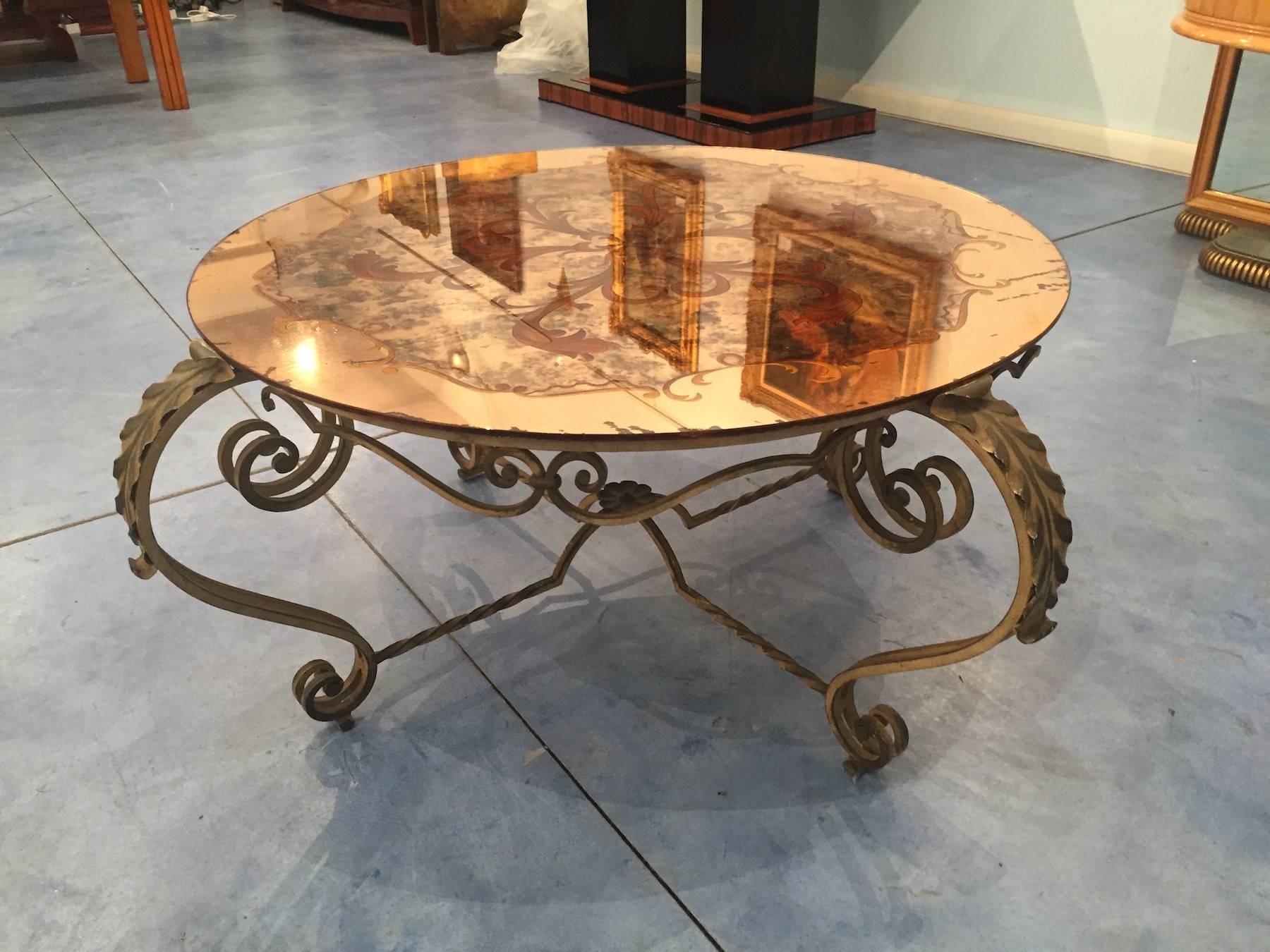 Beautiful tea table with base in wrought iron, splendid top made of an acid worked round mirror.