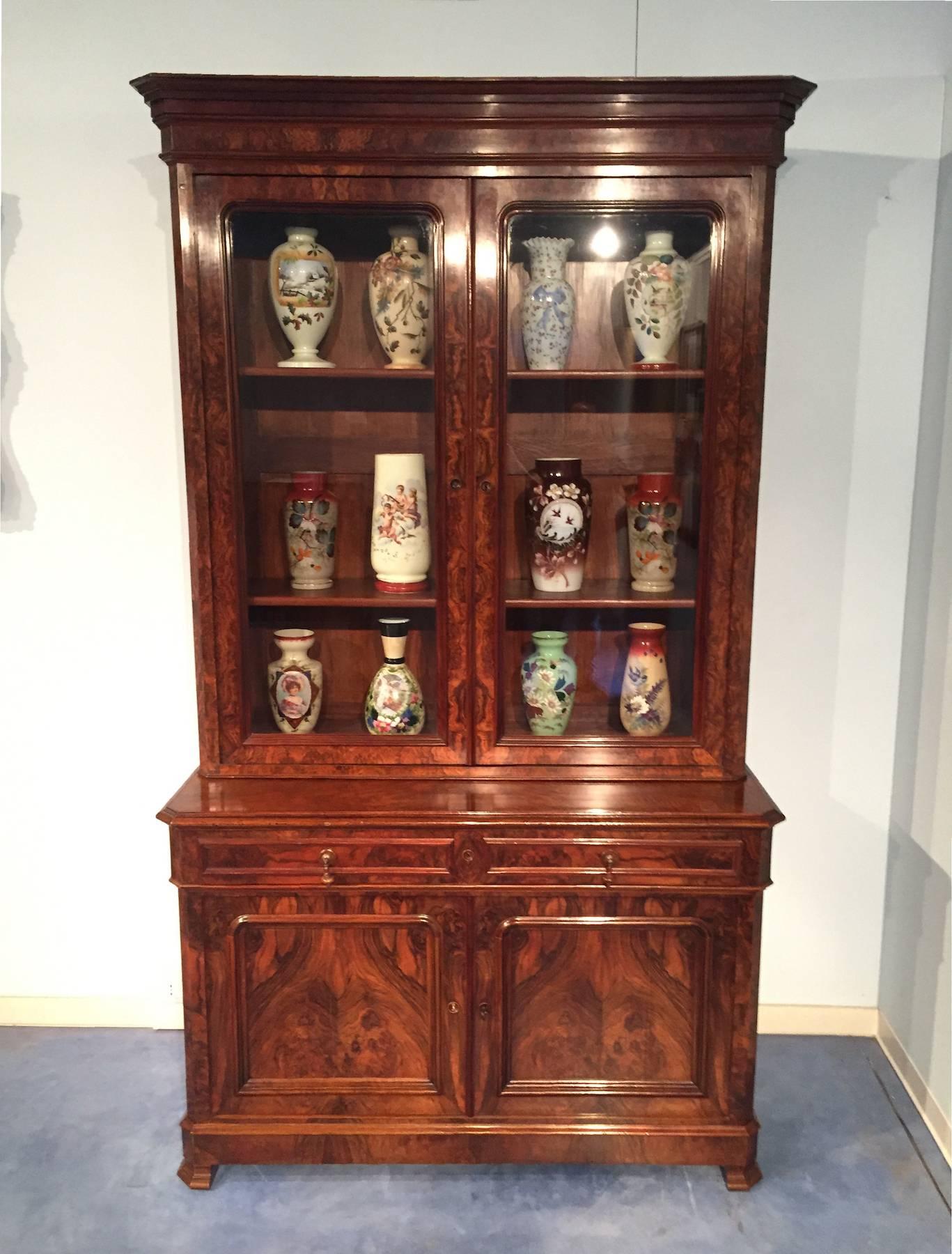 Beautiful French 19th century walnut bookcase bibliothèque, top sits opening reveal an interior with four adjustable shelves, the buffet base has two drawers and two doors, the radica walnut is richly toned and has acquired nice patina.
The piece