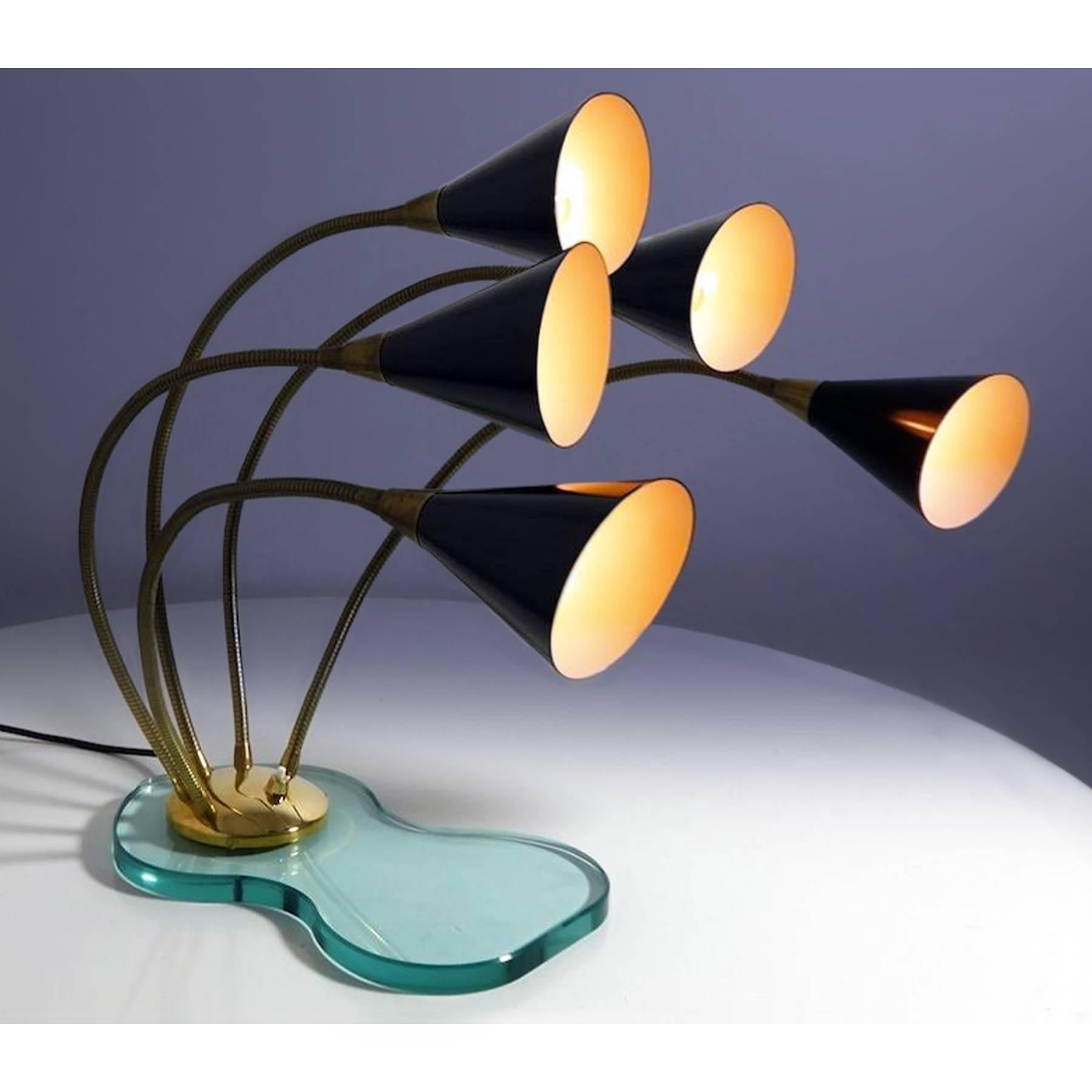 Amazing large table lamp five lights in Stilnovo style, finished with enameled black metal shades mounted on gooseneck brass arms and fixed on a beveled thick glass base.
It's a very stylish lamp with a unique design, offering adjustable infinite