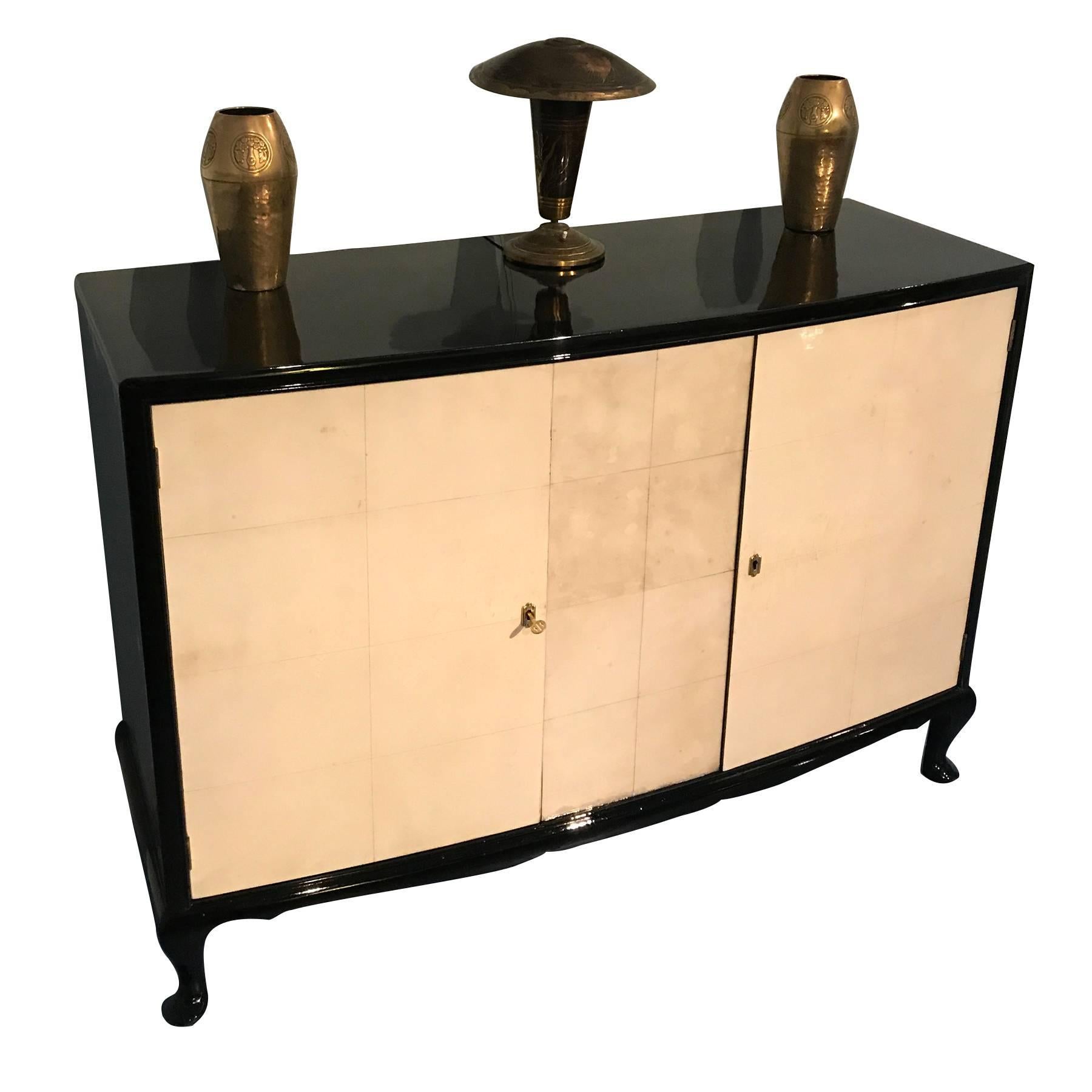 Elegant French Art Deco parchment sideboard manufactured in France in the 1950s.
Black lacquered side, top and legs. Clear lines and a simple but stylish shape.
Completely restored.