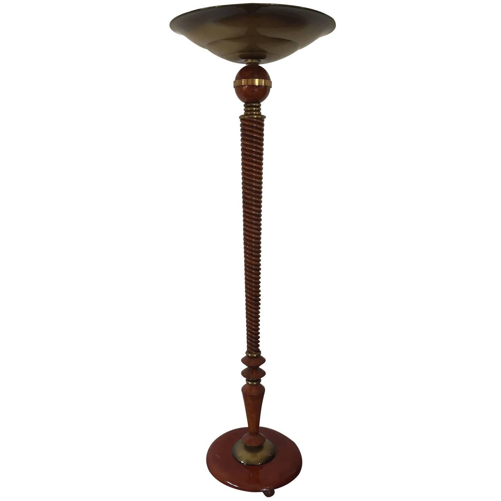 Unique French Art Deco floor lamp. Beautiful carved wood shaft design with superb brass decorations and circular base. The conditions of the period are very good with its original brass patina, fully functionally and ready to use. Recommended