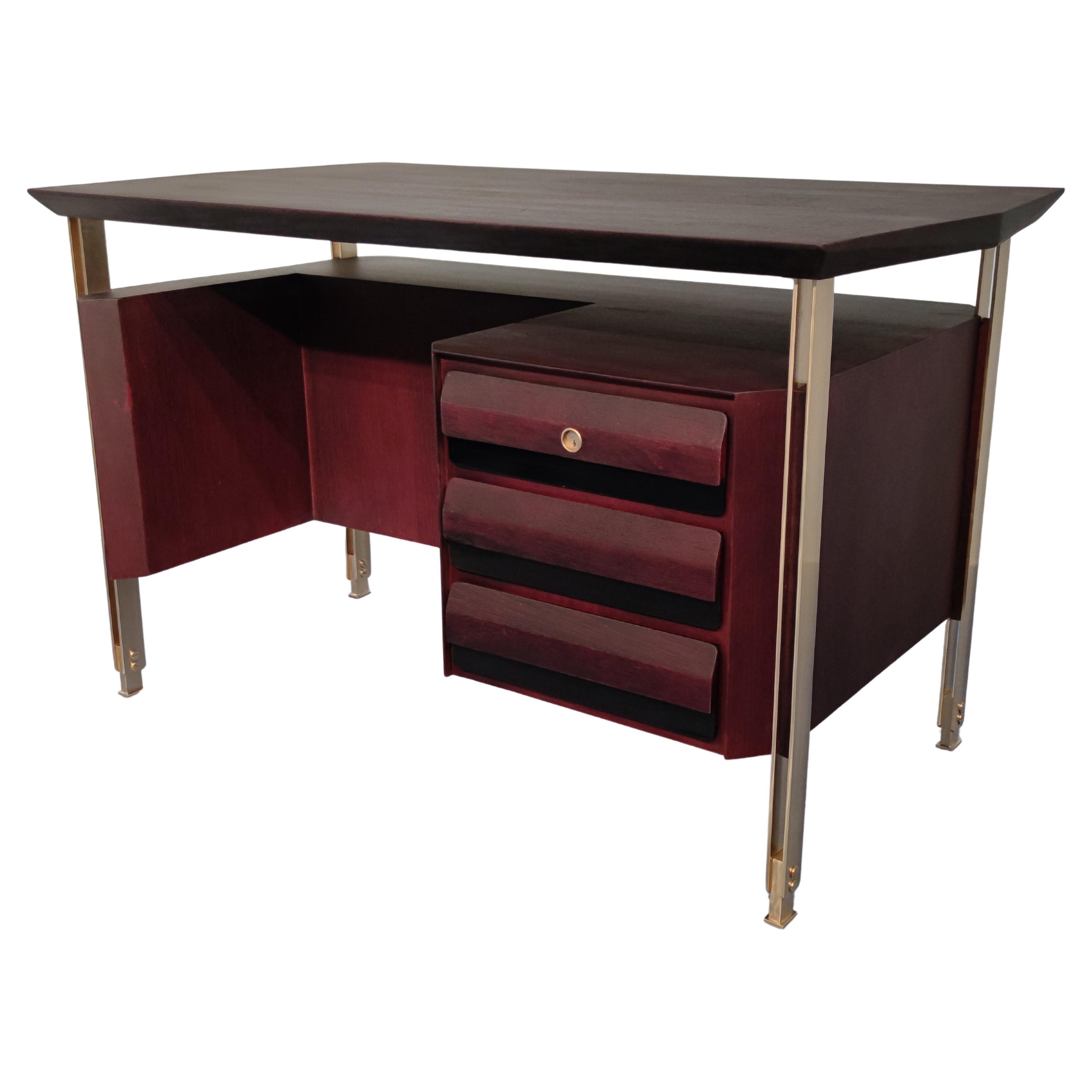 Stylish Italian Mid-Century Modern executive desk in bordeaux color designed by Vittorio Dassi in the 1960s. Hexagonal top shape, the double brass bar support with high adjustable legs has a really unique design. The three drawers with the final