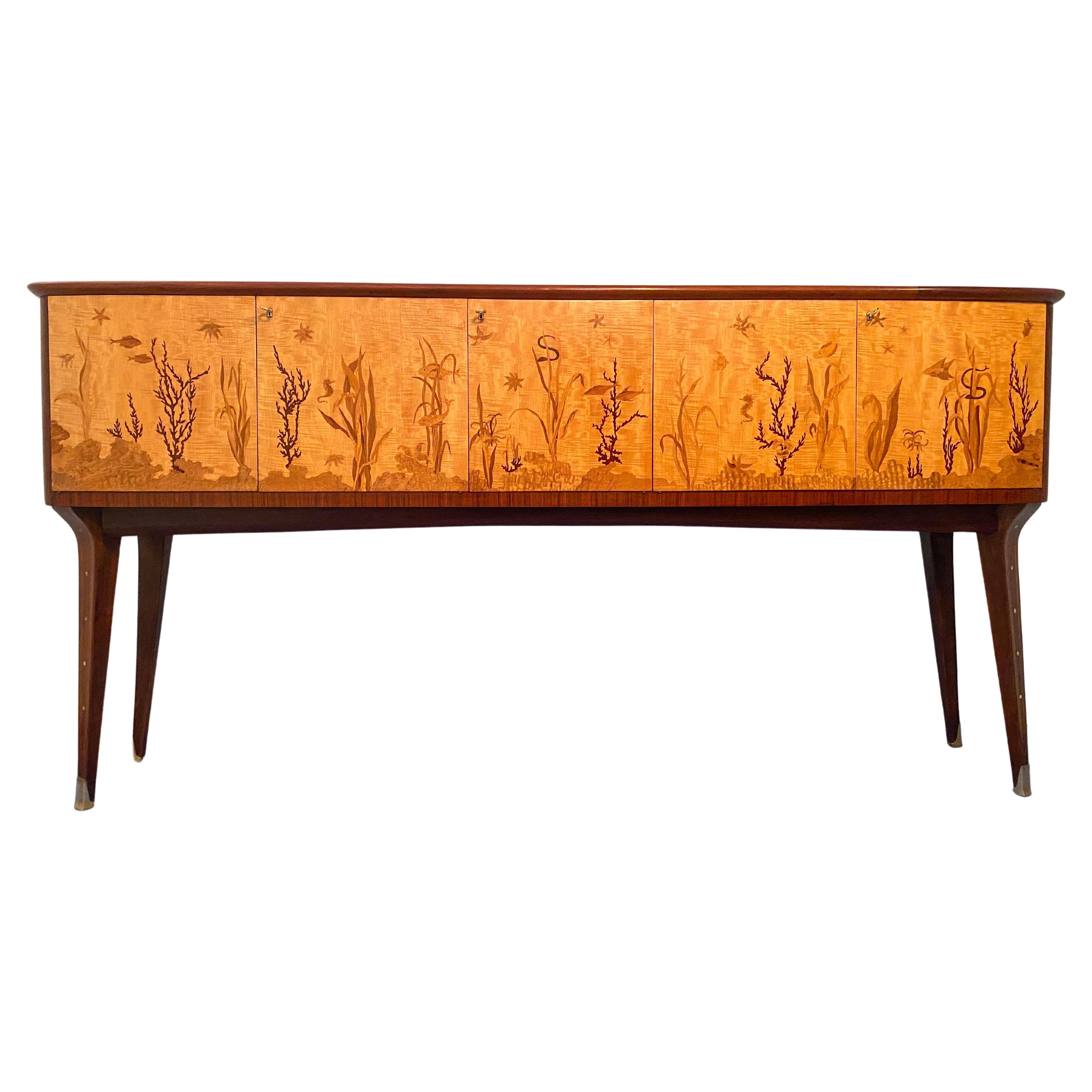 This Italian sideboard from the 1950s is truly exquisite, with its intricate hand-inlaid design by the renowned artist, inlayer, and marquetry master, Andrea Gusmai (Trani 1 May 1902-30 March 1992). The sideboard boasts an elegant and refined