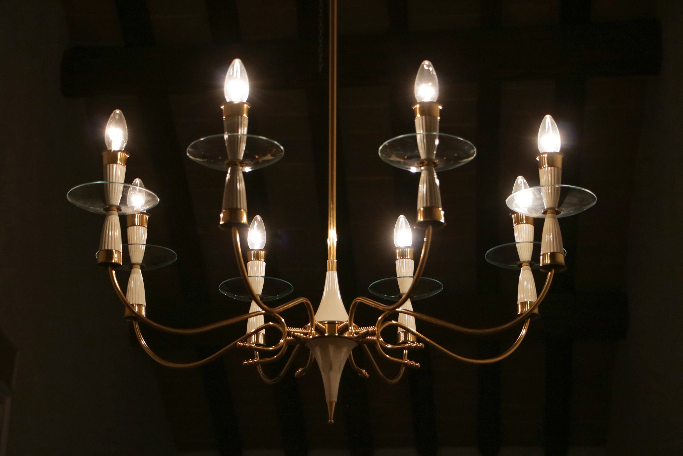 Experience the allure of this stunning Italian Mid-Century chandelier, reminiscent of Fontana Arte. Crafted from polished brass, ivory-lacquered aluminum, and polished glass, this piece showcases exceptional craftsmanship and meticulous attention to