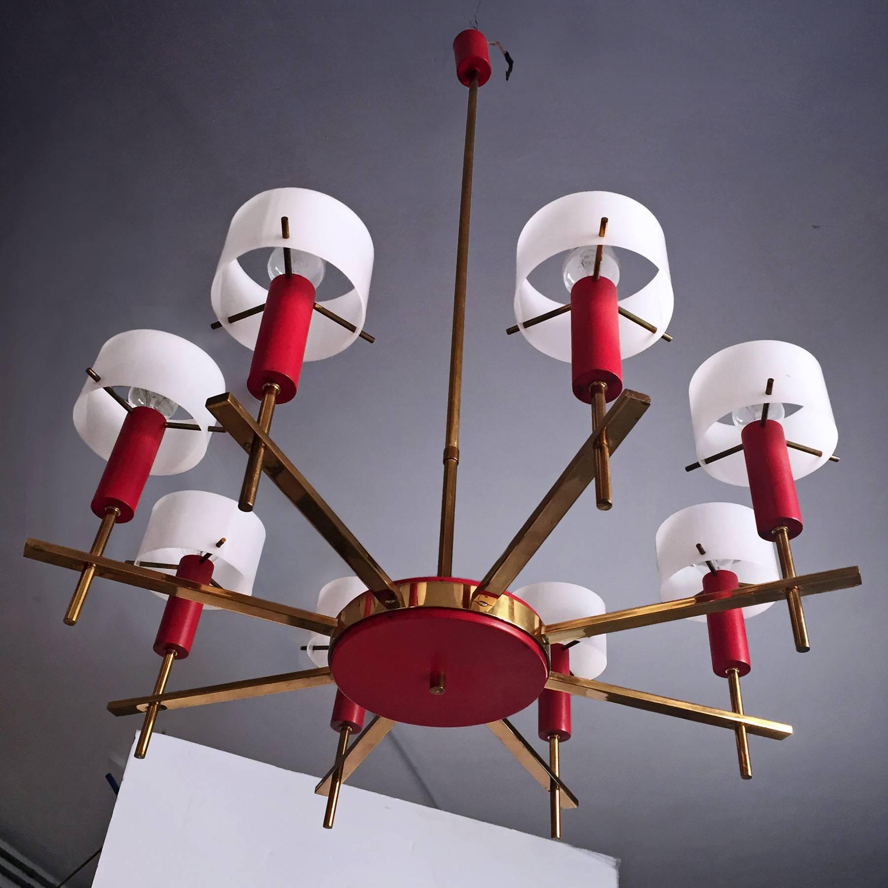 Rare and stylish Italian Chandelier eight-lights, designed by Angelo Brotto for Esperia in the 1950s.
The solid multi-arm brass structure is equipped with lamp metal bodies painted in lacquered red and light diffusers in white plexiglass.
All the