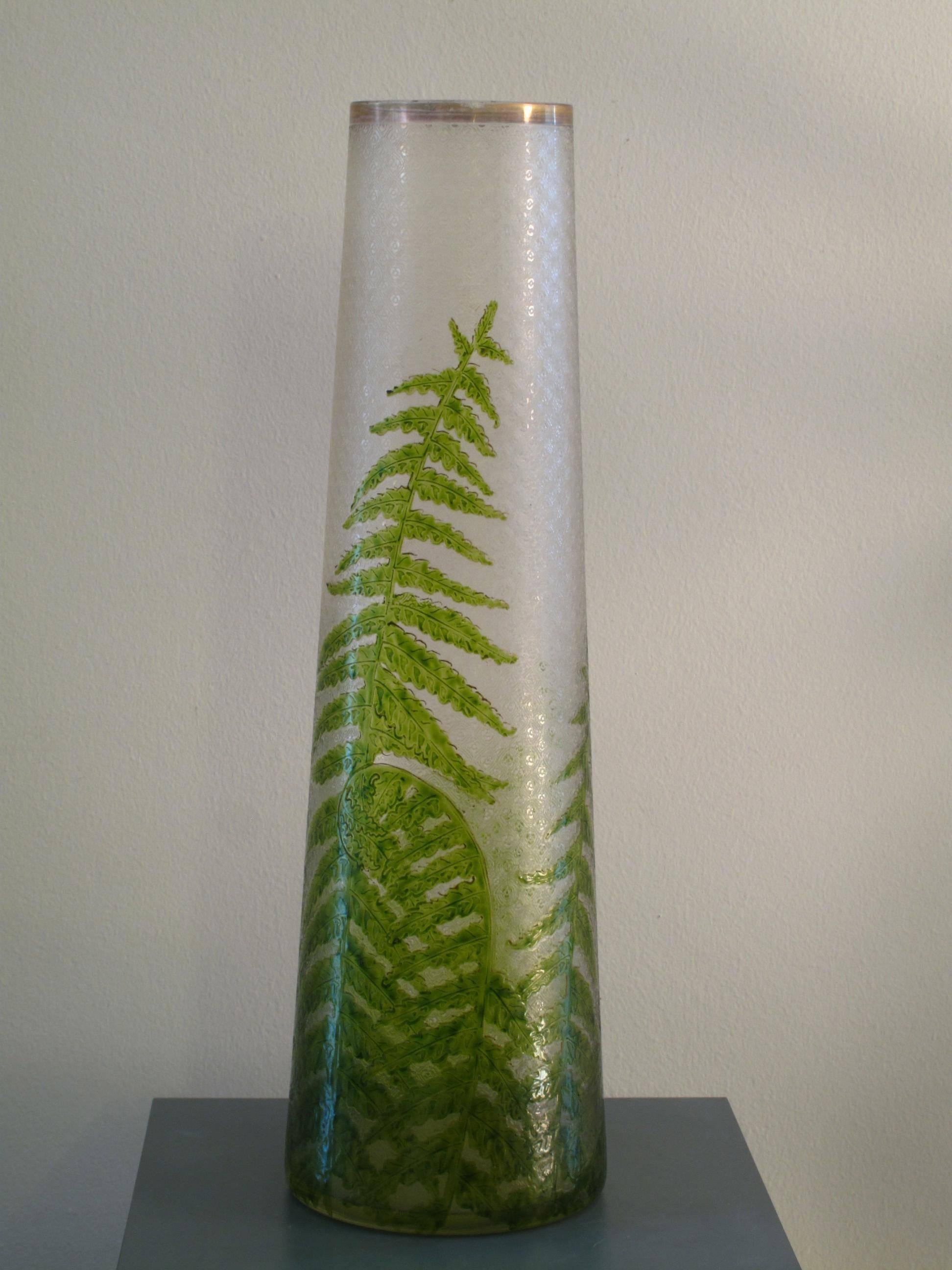Tall French vase in textured art glass with metallic lip. Hand-painted with intricate fern design. Vase tapers from 6 in. diameter to 3 in. diameter at top.