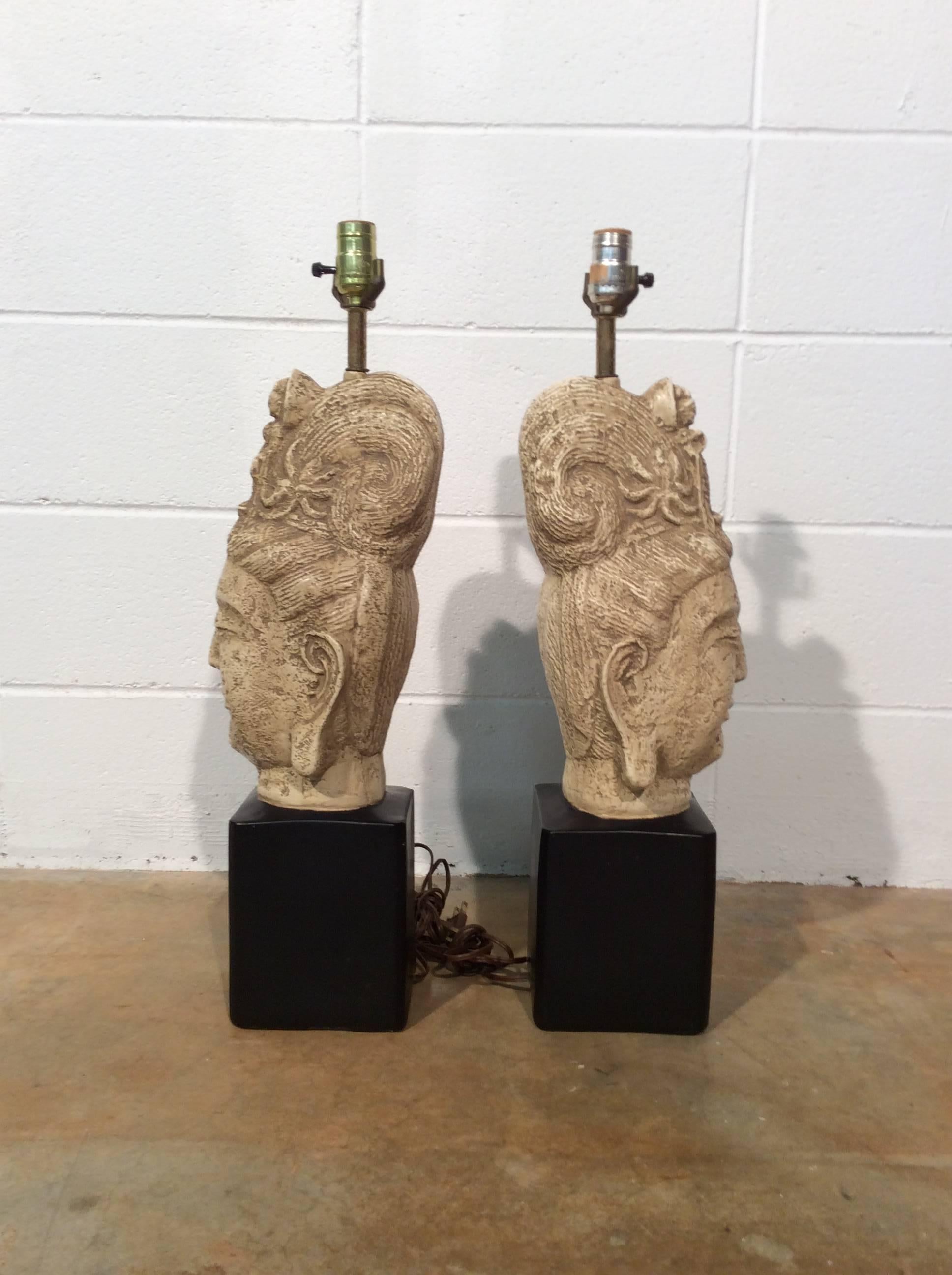 A stunning and sought after pair of ceramic Buddha lamps attributed to James Mont. Lamps are in as found condition with only very minimal wear. Looks like one socket has been replaced. Lamps are in working order with no major issues to report.