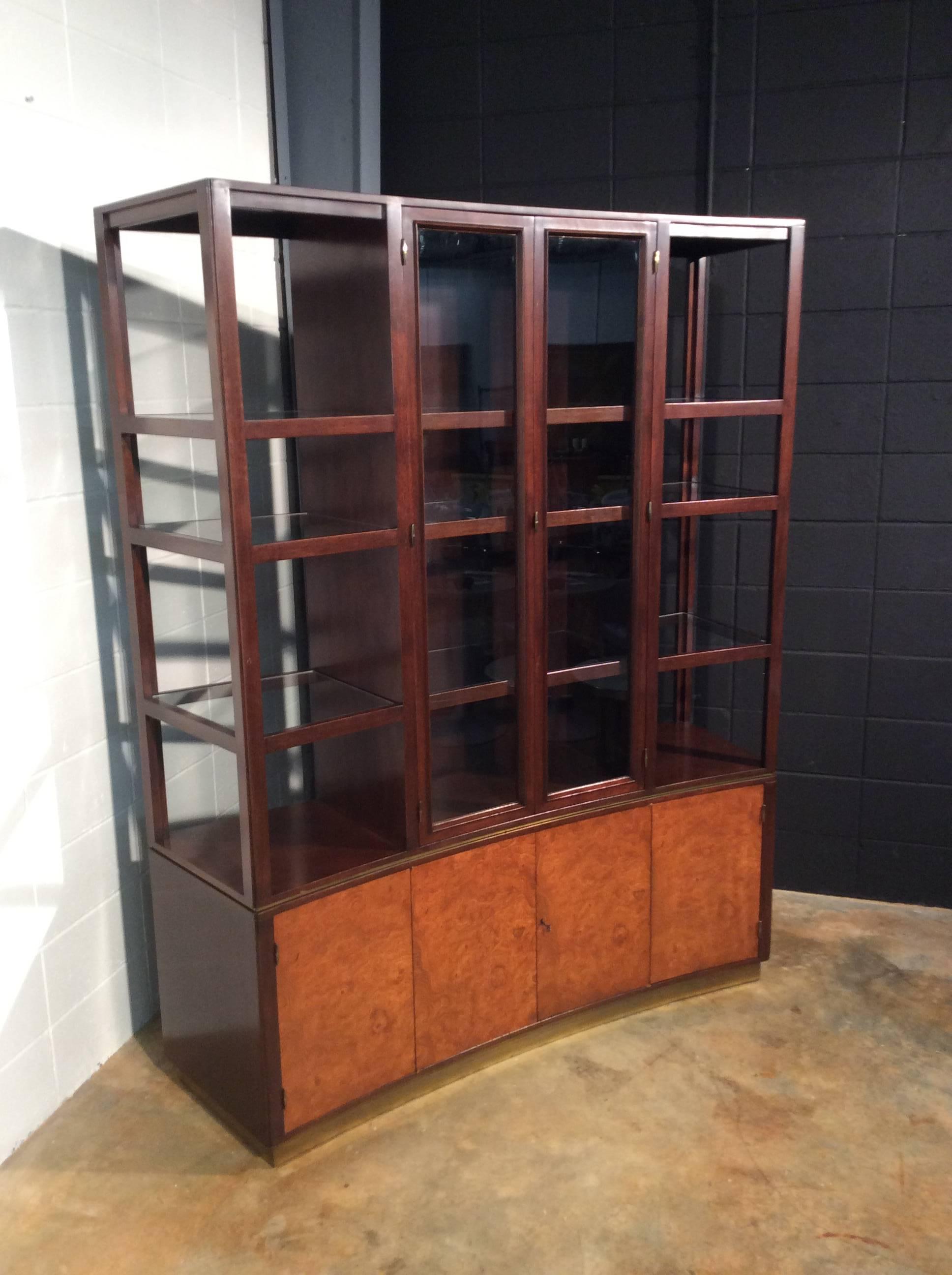 Timeless curved display cabinet superstructure designed by Edward J Wormley for Dunbar -Model No 6027. At 80 inches tall and constructed from Mahogany and Burl, this statement piece will add plenty of display space to a room. Very versatile and