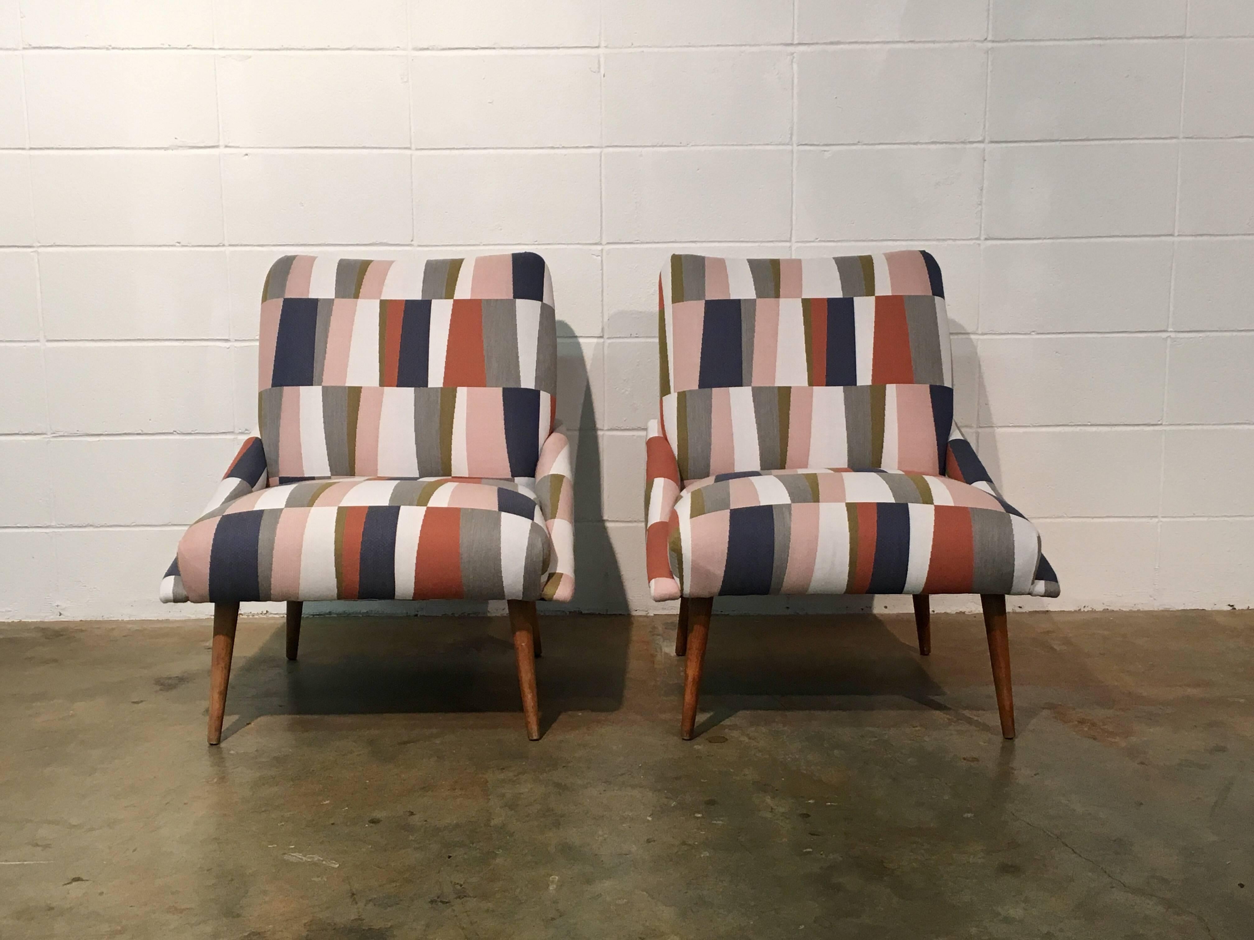 Mid-Century Modern slipper chairs restored, including new foam and upholstery. Geometric fabric in cool colors resting on sleek wood taper legs. Restored, no known issues.