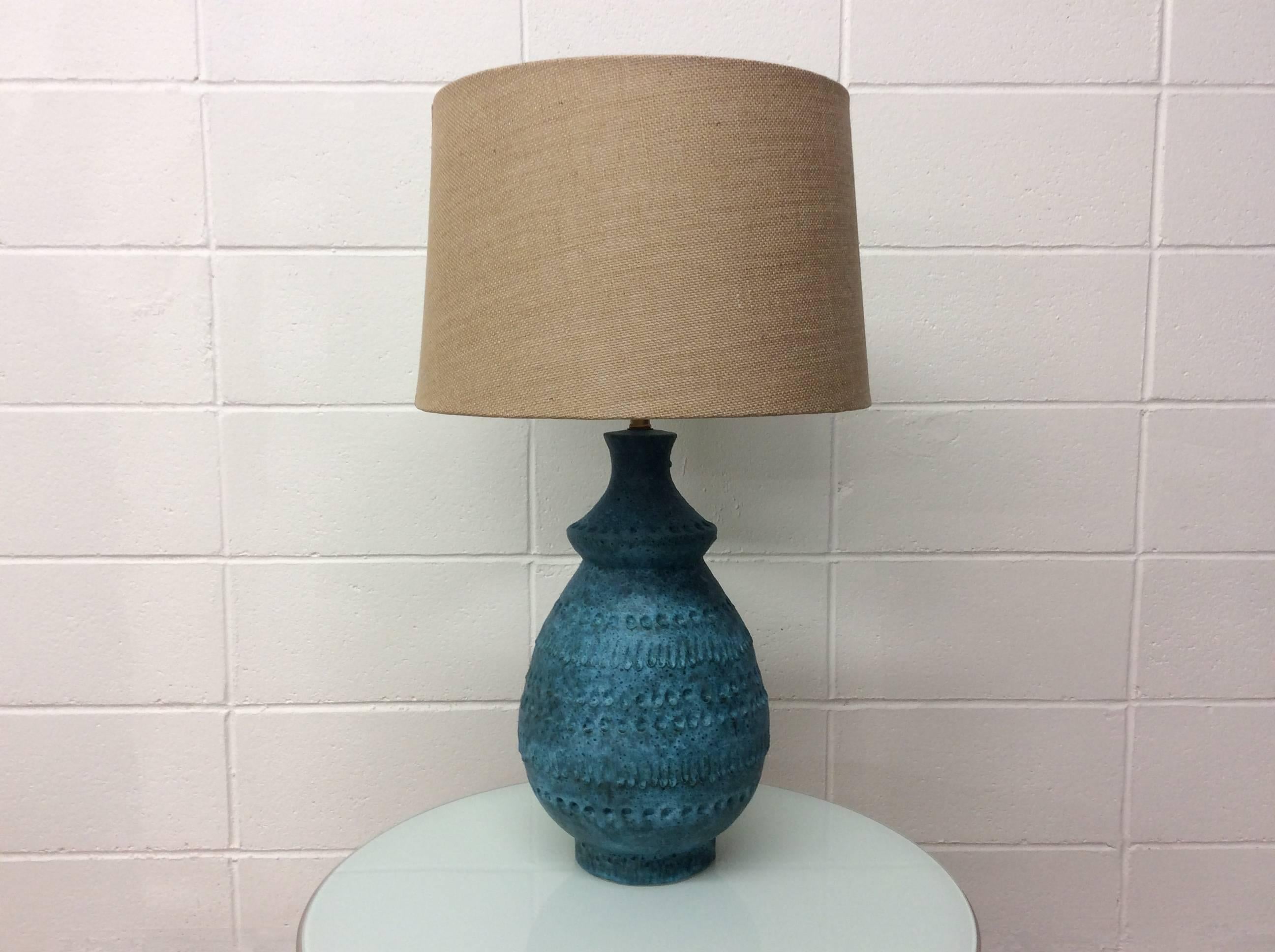 Mid-Century Modern Italian ceramic lamp in blue with the teardrop or lacrima pattern. Believed to be Bitossi. Signature not found. The lamp has new wiring and a new shade. 
No known issues. Ready for use.

Shade dimensions
15