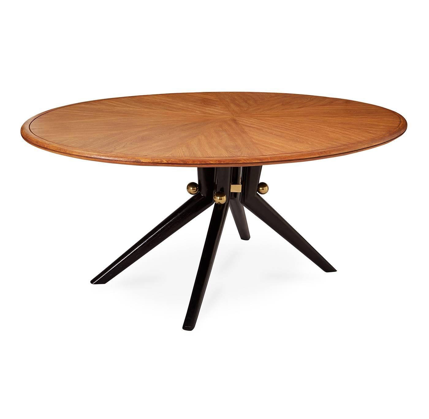 Divine dining. A sculptural splayed leg base with brass spheres supports an oval, honeyed wood top that has been wire brushed in a radial pattern to showcase the natural grain. The slight, Scandinavian style distressing of the top makes it extra