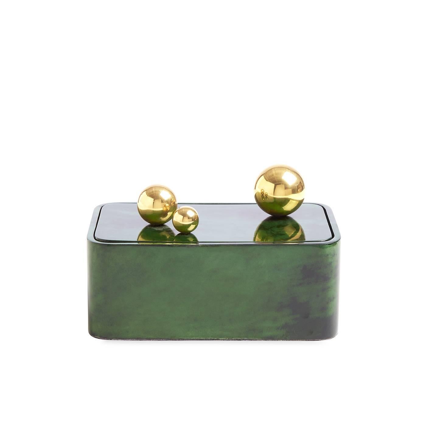 Lacquered goatskin meets polished brass spheres in our elementally simple Trocadero Box. Jonathan aimed to pare down basic shapes for a box that makes the most minimal gestures functional and dynamic. Generously sized and uncompromisingly glamorous,