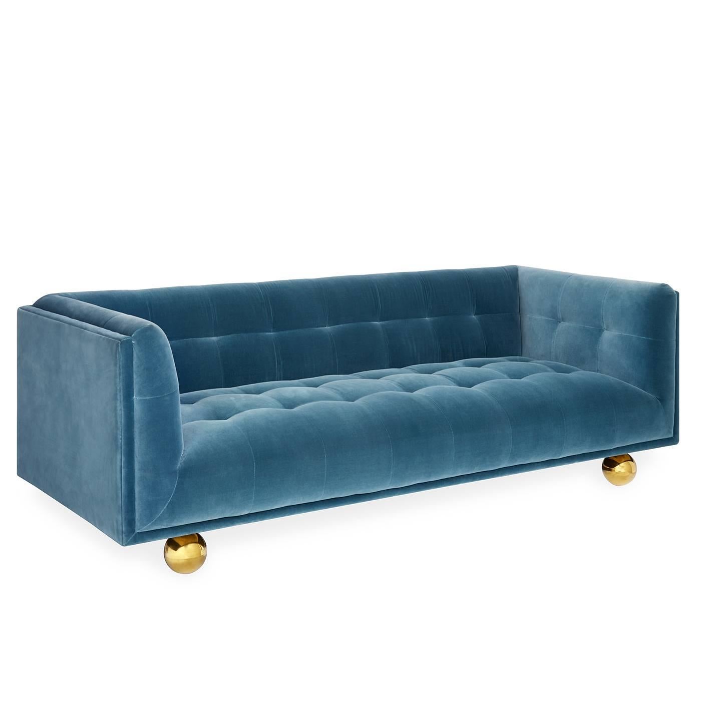 The Chesterfield sofa gets a Modern American Glamour update. We took the guts of a Chesterfield (clubby comfort and tailored tufting) and encased them in a pared down Silhouette. The finishing touch: we perched the haute hybrid on oversized brass