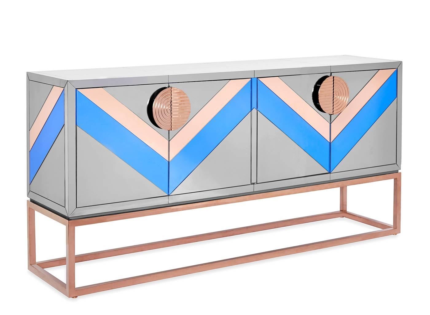 Avant antique. With a nod to Neo-Memphis style and a wink of Modern American Glamour, consider this the credenza gone cutting edge. Our Nouvelle credenza features a mirrored case in tones of smoke, cobalt, and copper perched on a minimalist cube