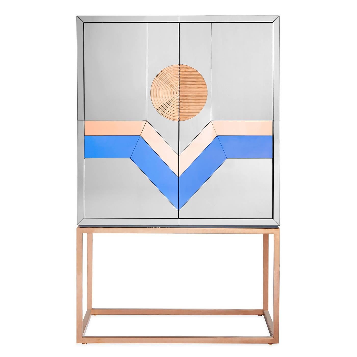 Avant antique. With a nod to neo-Memphis style and a wink of modern American glamour, our nouvelle bar is the most cutting edge spot to mix a drink. Featuring a mirrored case in tones of smoke, cobalt, and copper perched on a Minimalist cube base