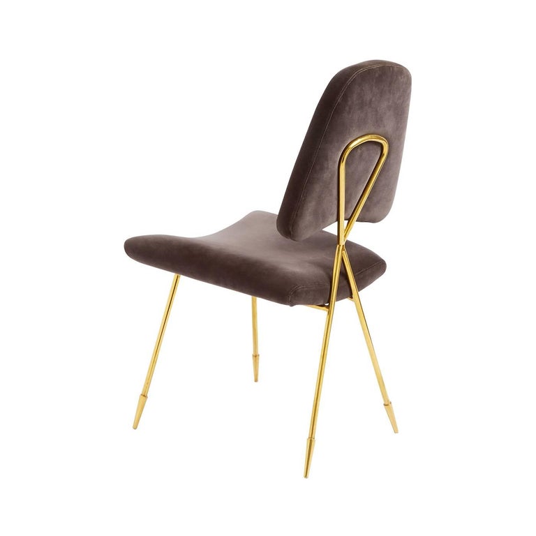Modern elegance. A gleaming brass frame with an intriguing crisscross back and our signature sabots cradles a softly curved seat and sculptural back. But don't be fooled by the sinuous frame the Maxime dining chair is very comfy. Upholstered in luxe