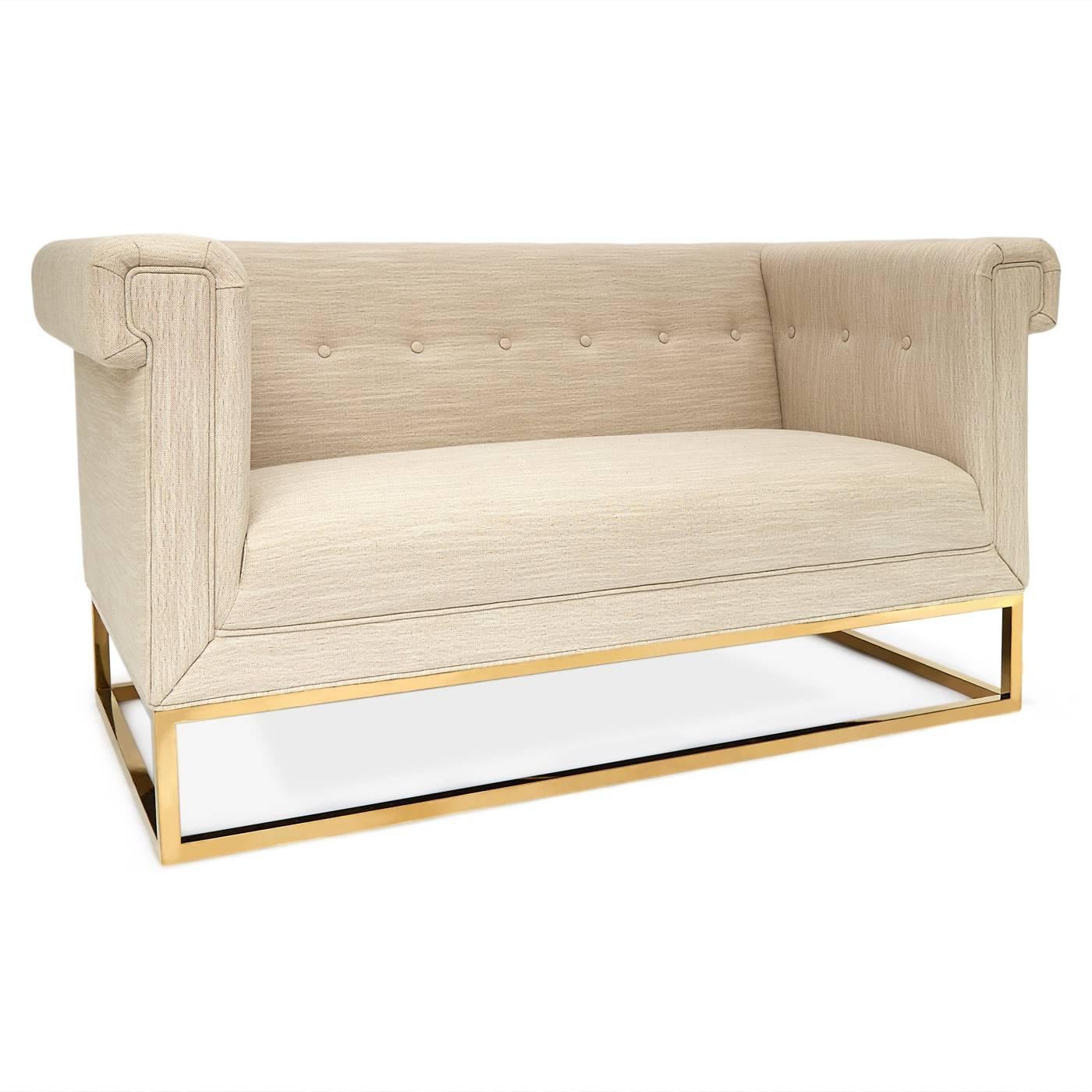 New Traditionalism. Modern minimalism meets traditional English in our Caine settee. High tuxedo arms and mitered seams create a tailored profile while the polished brass base screams luxury. This settee is sized for smaller spaces and doesn't