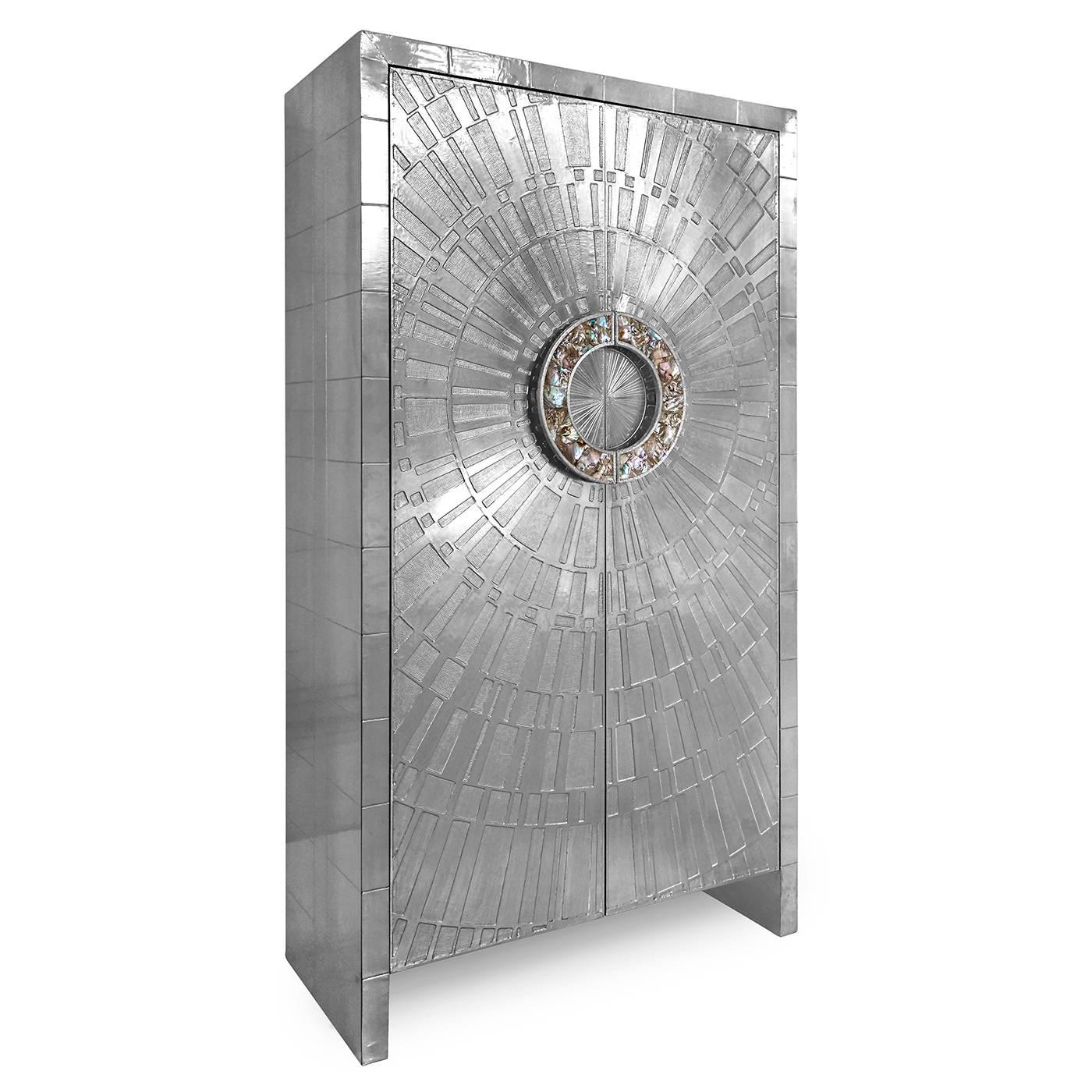 Global glamour. Crafted from nickel-plated metal with hand-stamped patterns applied to Minimalist and modernist forms. The surface is reminiscent of silver leaf—it emits that same lustrous glow—but is wonderfully durable.

Our Talitha Armoire is