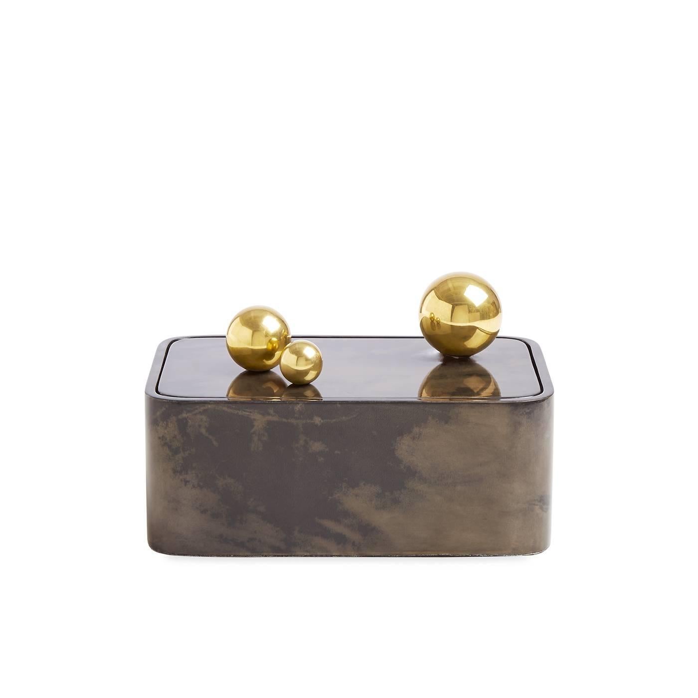 Lacquered goatskin meets polished brass spheres in our elementally simple Trocadero Box. Jonathan aimed to pare down basic shapes for a box that makes the most minimal gestures functional and dynamic. Generously sized and uncompromisingly glamorous,