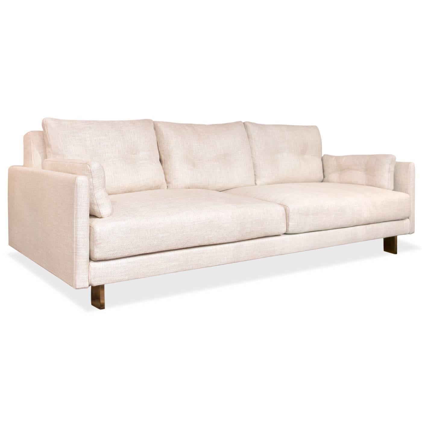 California Modern. Deep and squishy, family-friendly, and très chic you can have it all. Upholstered in Mulholland Pearl bouclé with minimal brushed brass legs. Combine details like inviting pin-tucked back and side cushions, with removable,