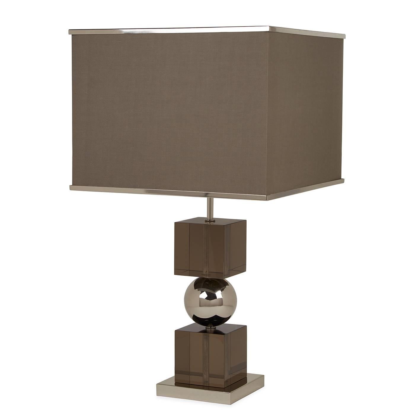 Clearly cool. Traditional elegance meets modern glamour in our Jacques stacked table lamp. Moody smoked Lucite cubes sandwich a stainless steel ball for gravity-defying glamour. A polished nickel trim gives a jewelry-like finish to the square fabric